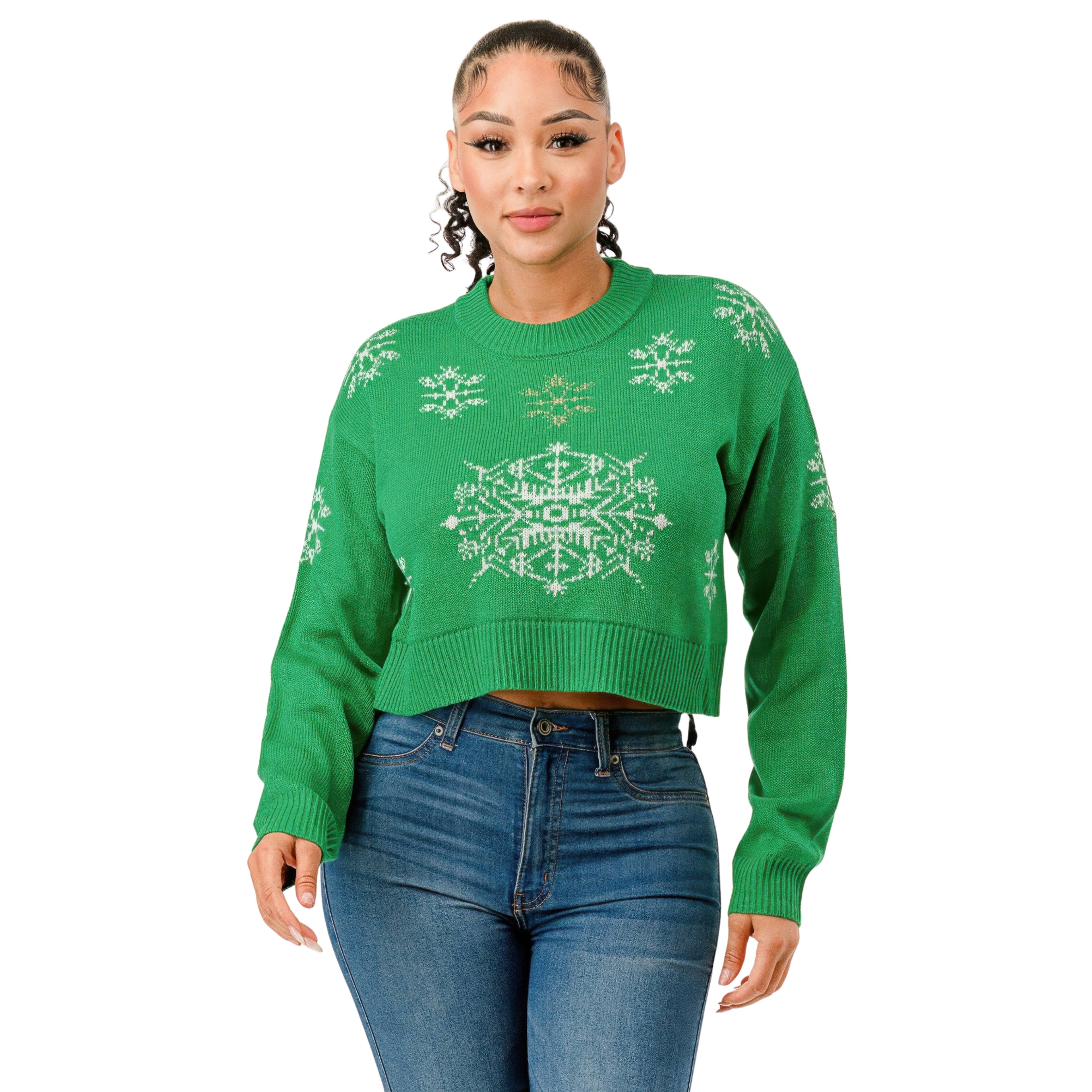 Woman wearing a green sweater with white snowflake patterns on a white background