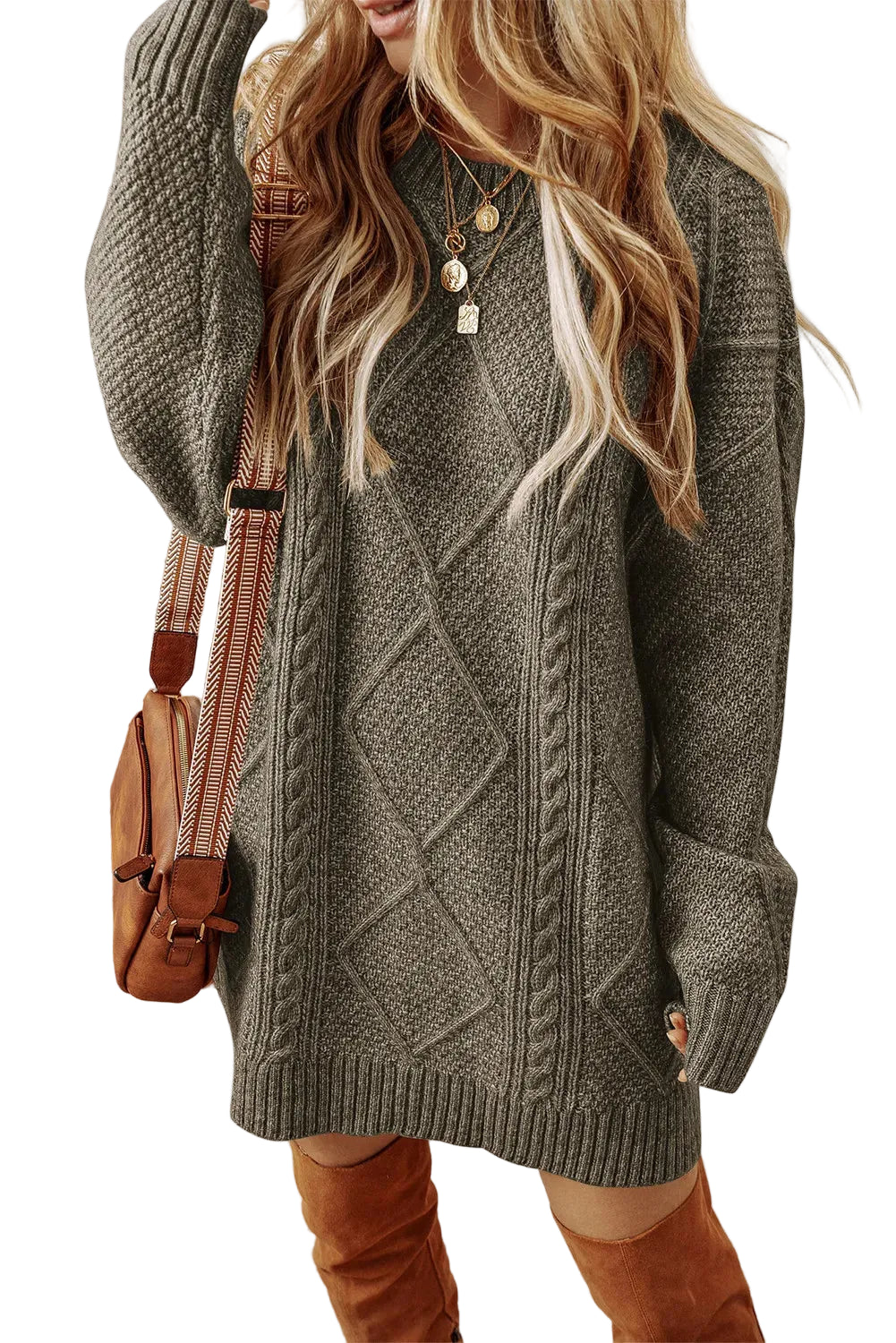 Woman wearing a gray cable knit sweater with a white background