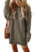 Woman wearing a gray cable knit sweater with a white background