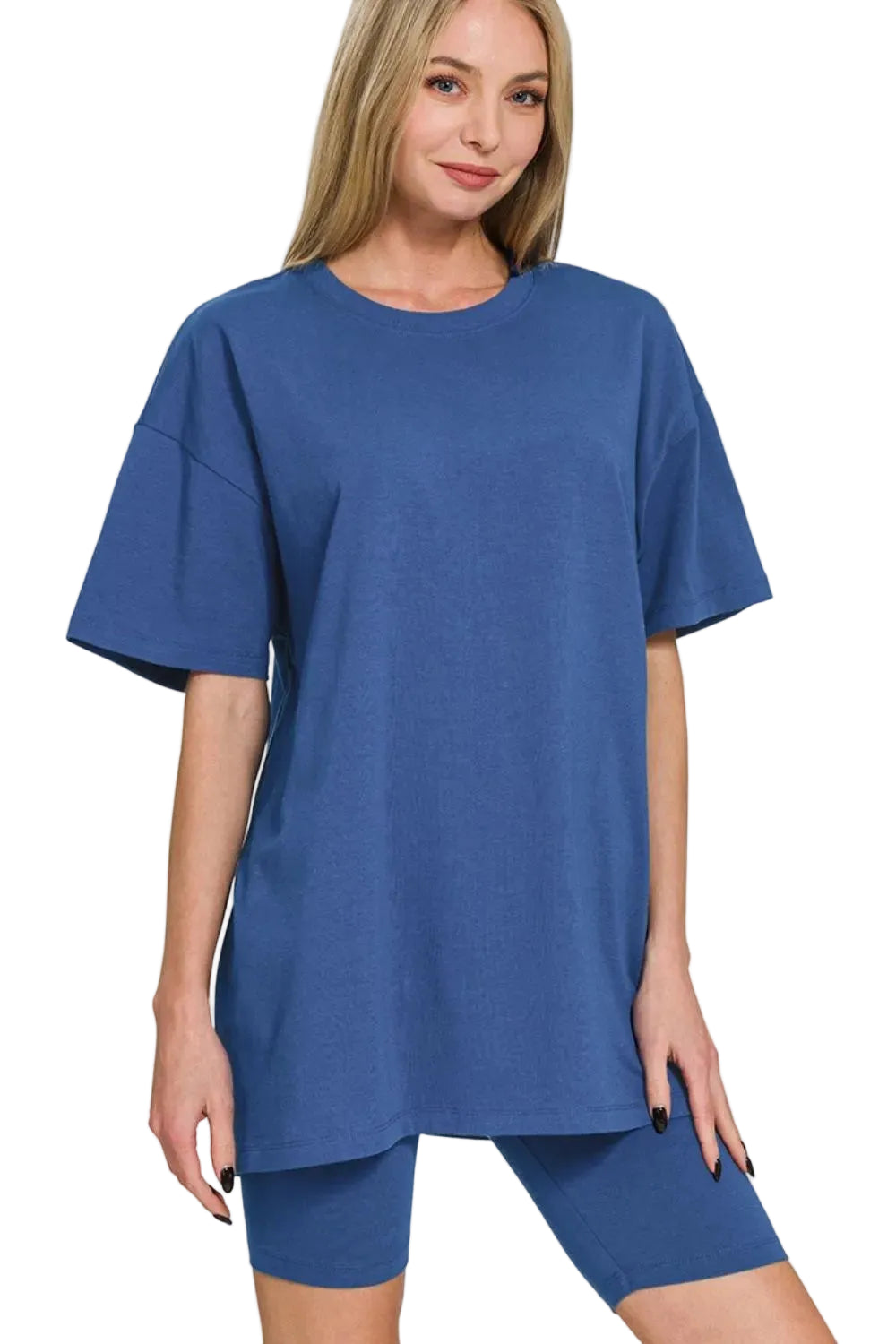 Woman wearing a blue oversized t-shirt and shorts on a white background