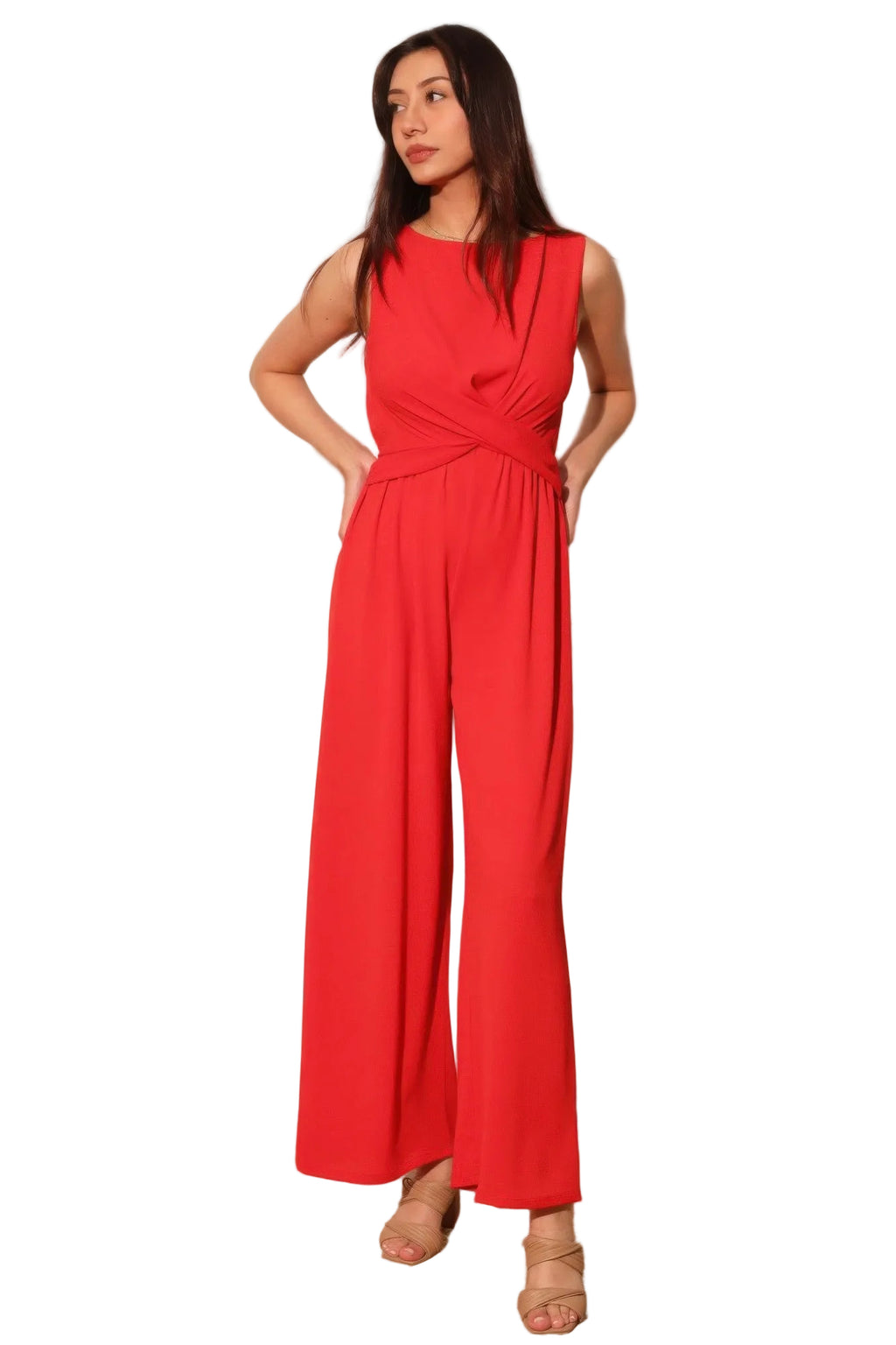 Woman wearing a red jumpsuit against a plain background