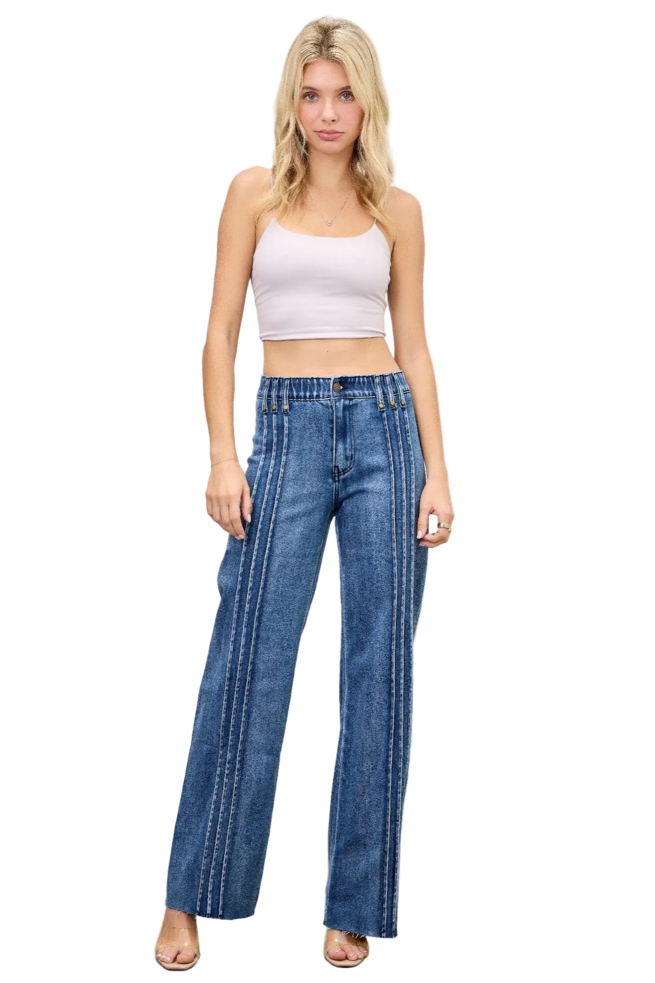 Woman wearing blue jeans and a white top on a white background