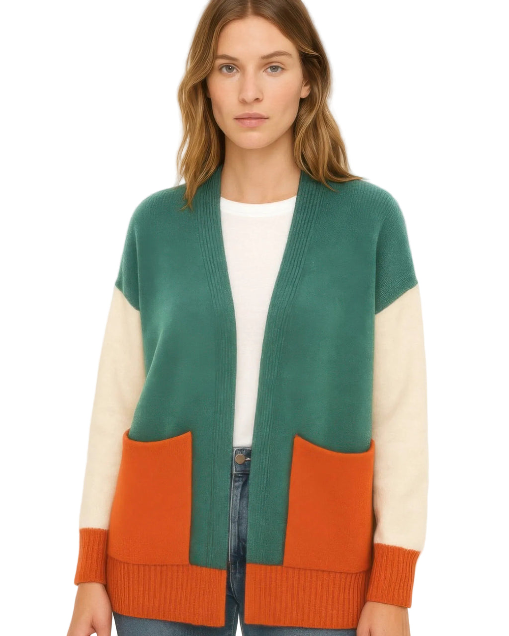 A woman wearing a color-blocked knit cardigan with a teal green body, cream sleeves, and orange pocket panels, styled over a white t-shirt and jeans against a plain white background.