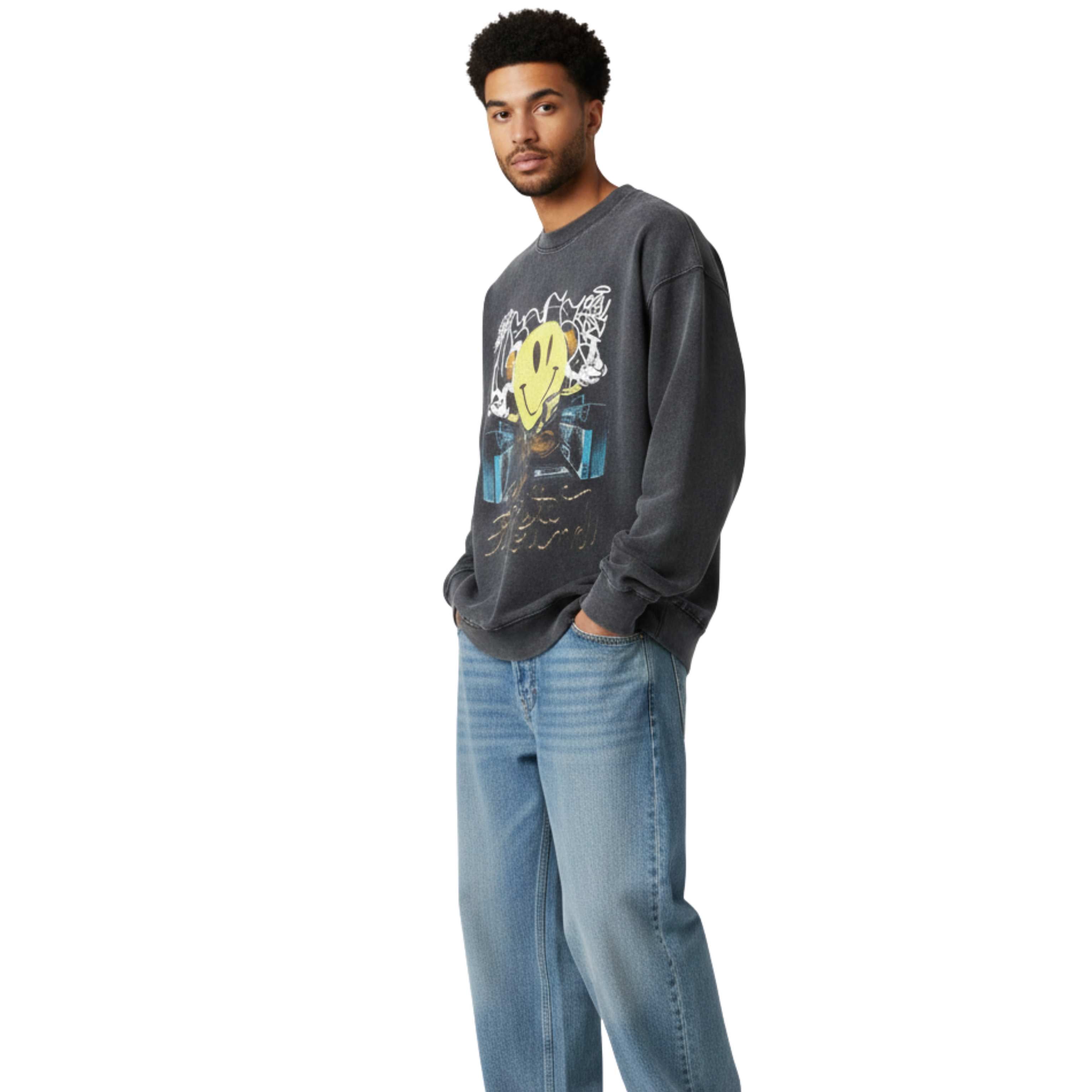 Man wearing a graphic sweatshirt and jeans on a white background