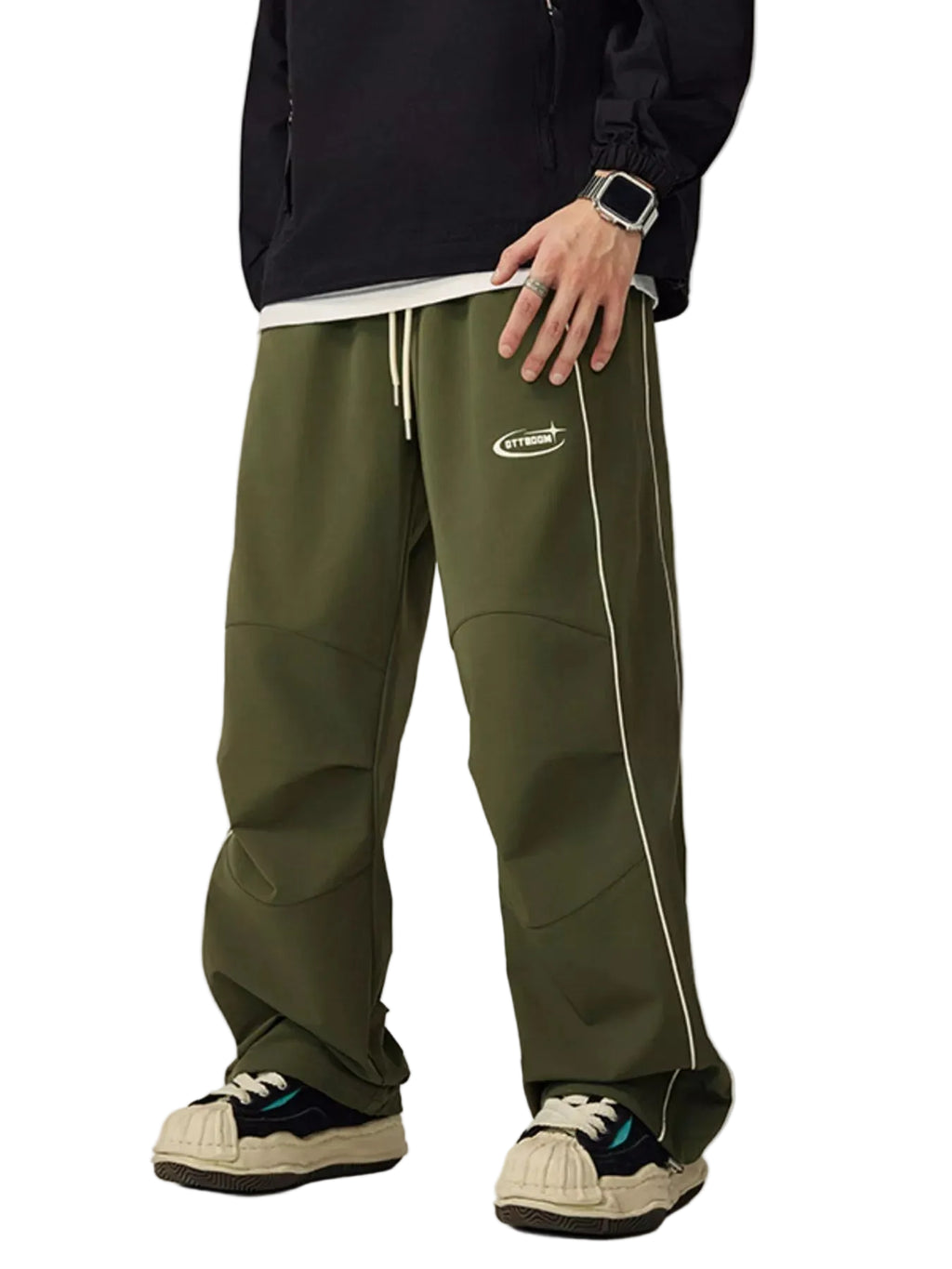 Person wearing green pants with a brand logo on a plain background