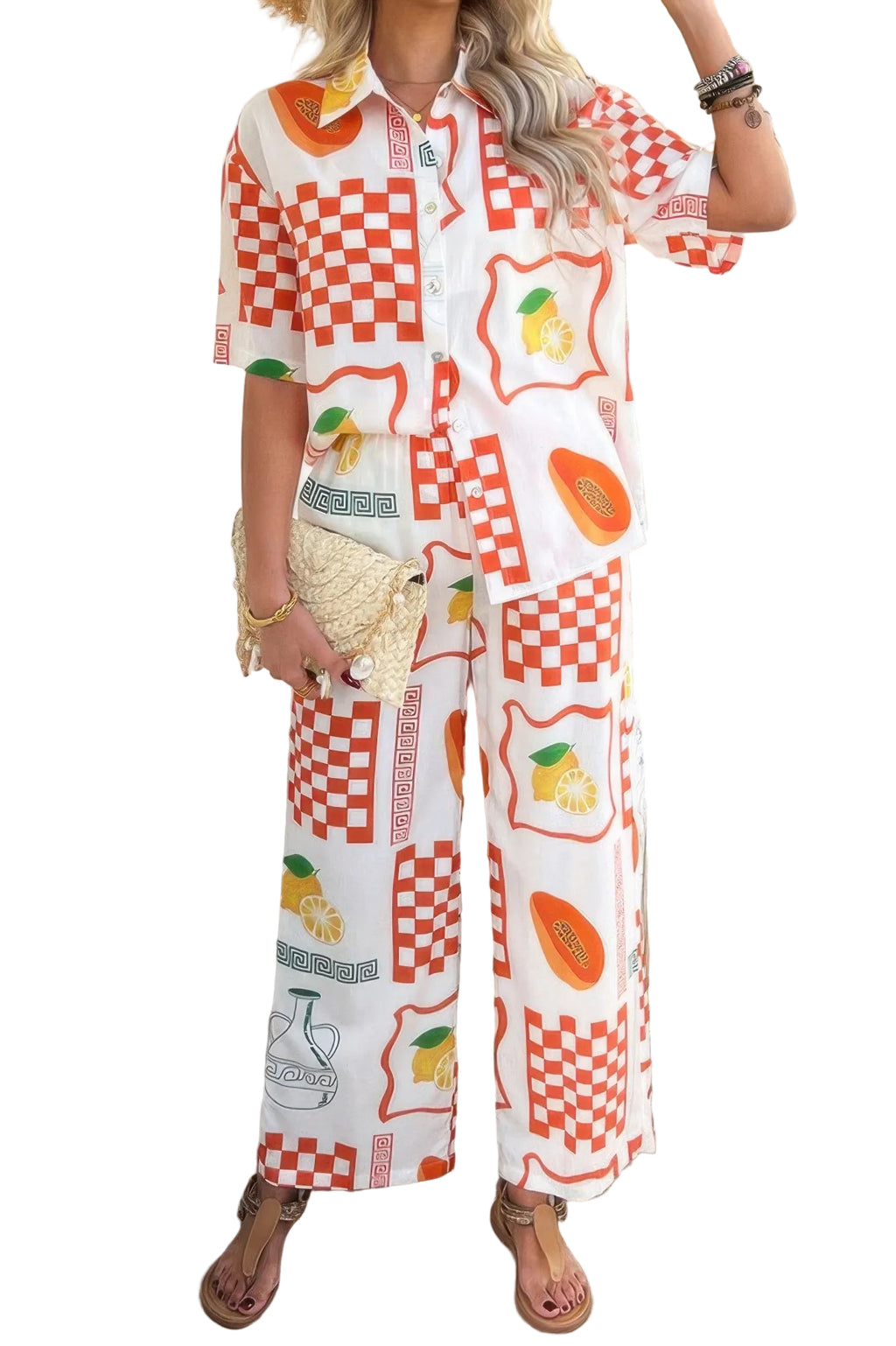 Person wearing a colorful outfit with a pattern of fruits and geometric shapes, standing indoors.
