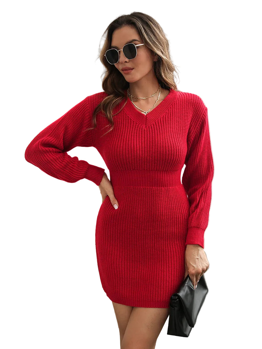 Woman wearing a red sweater dress with sunglasses and a black clutch.