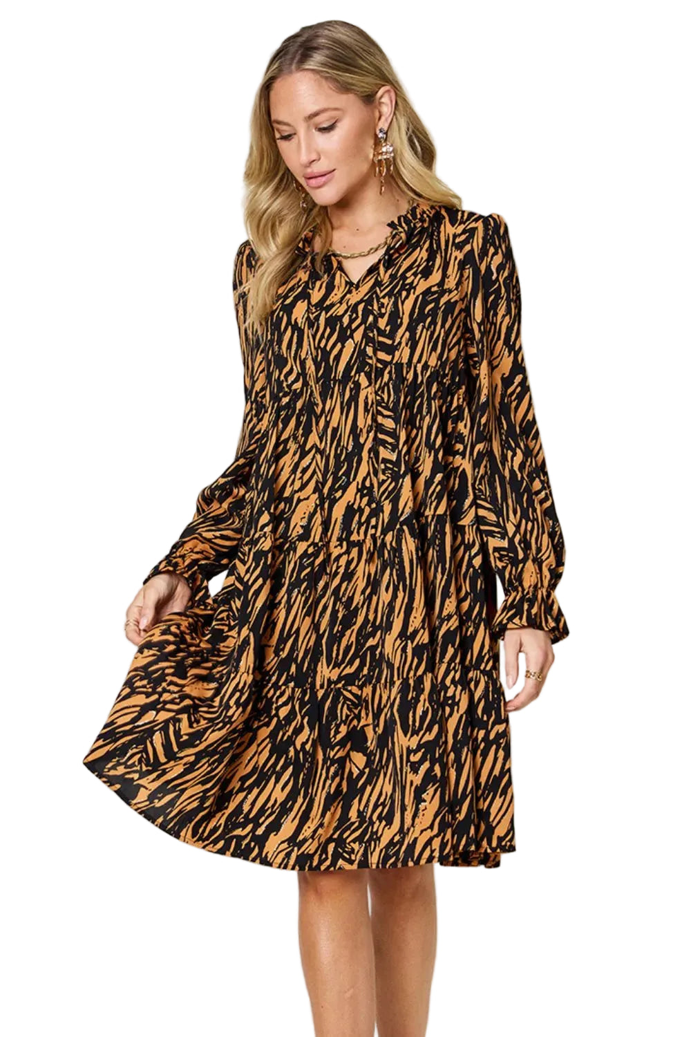 Woman wearing a patterned dress against a plain background