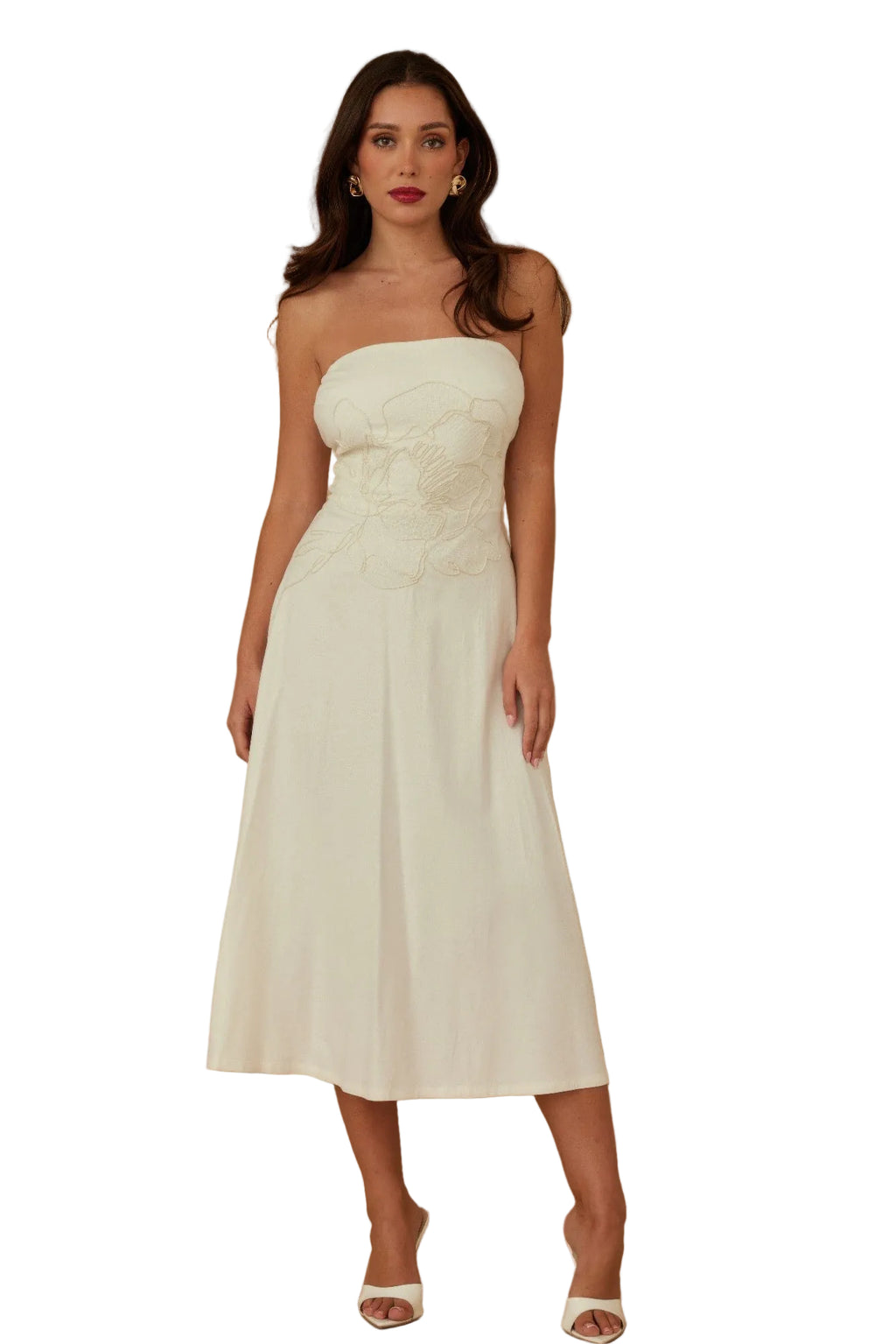 Woman wearing a strapless white dress against a brown background