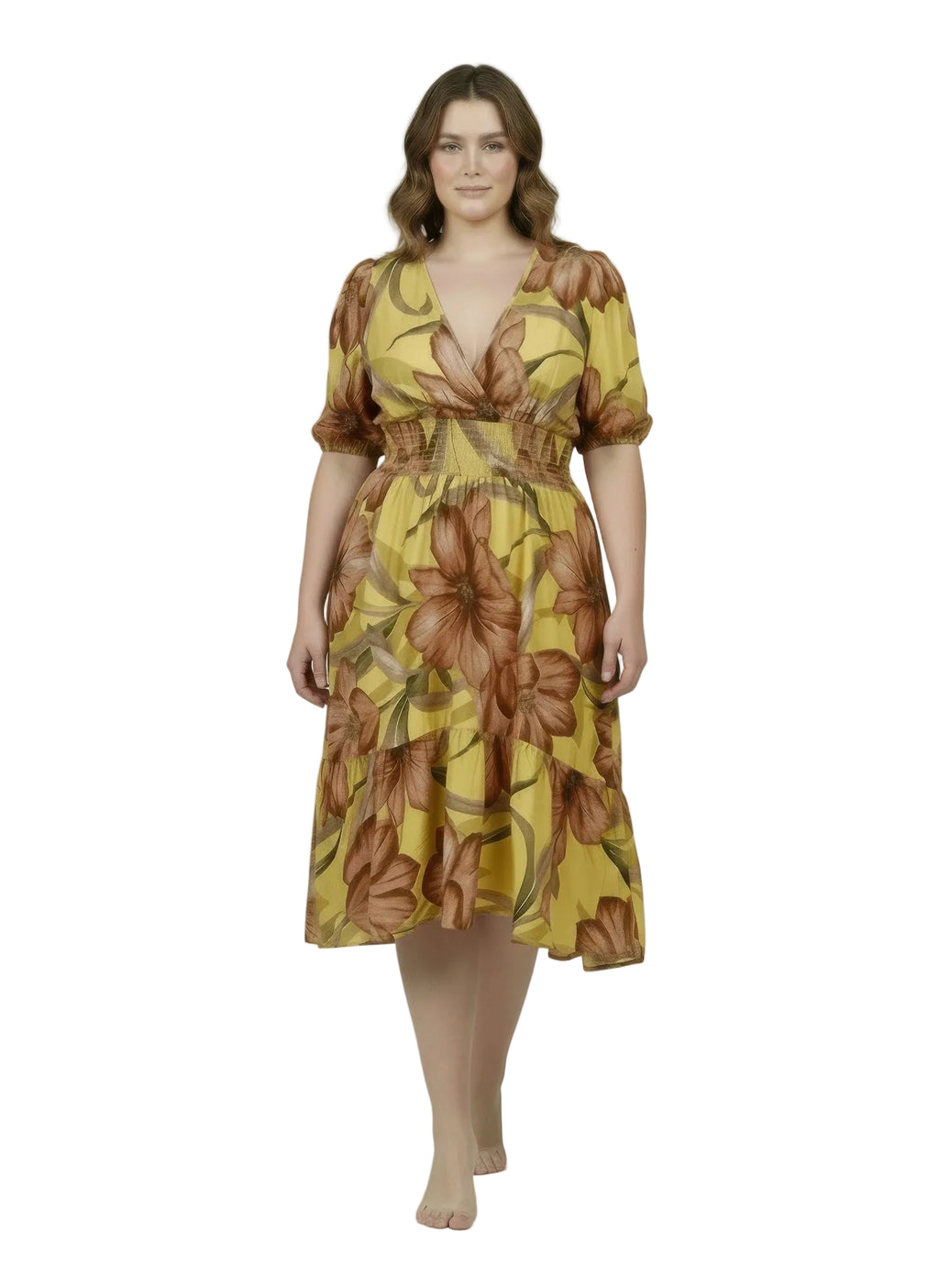 Woman wearing a yellow floral dress on a plain background