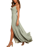 Woman wearing a light blue dress with a slit on a beige background