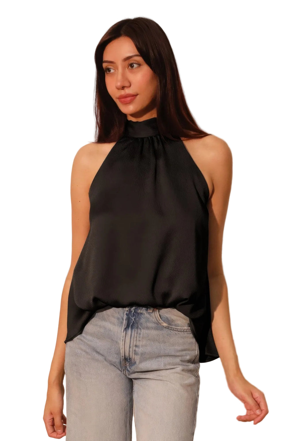 Woman wearing a black halter top and light blue jeans against a plain background
