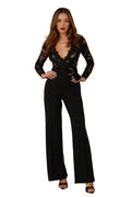 Woman wearing a black lace jumpsuit on a beige background