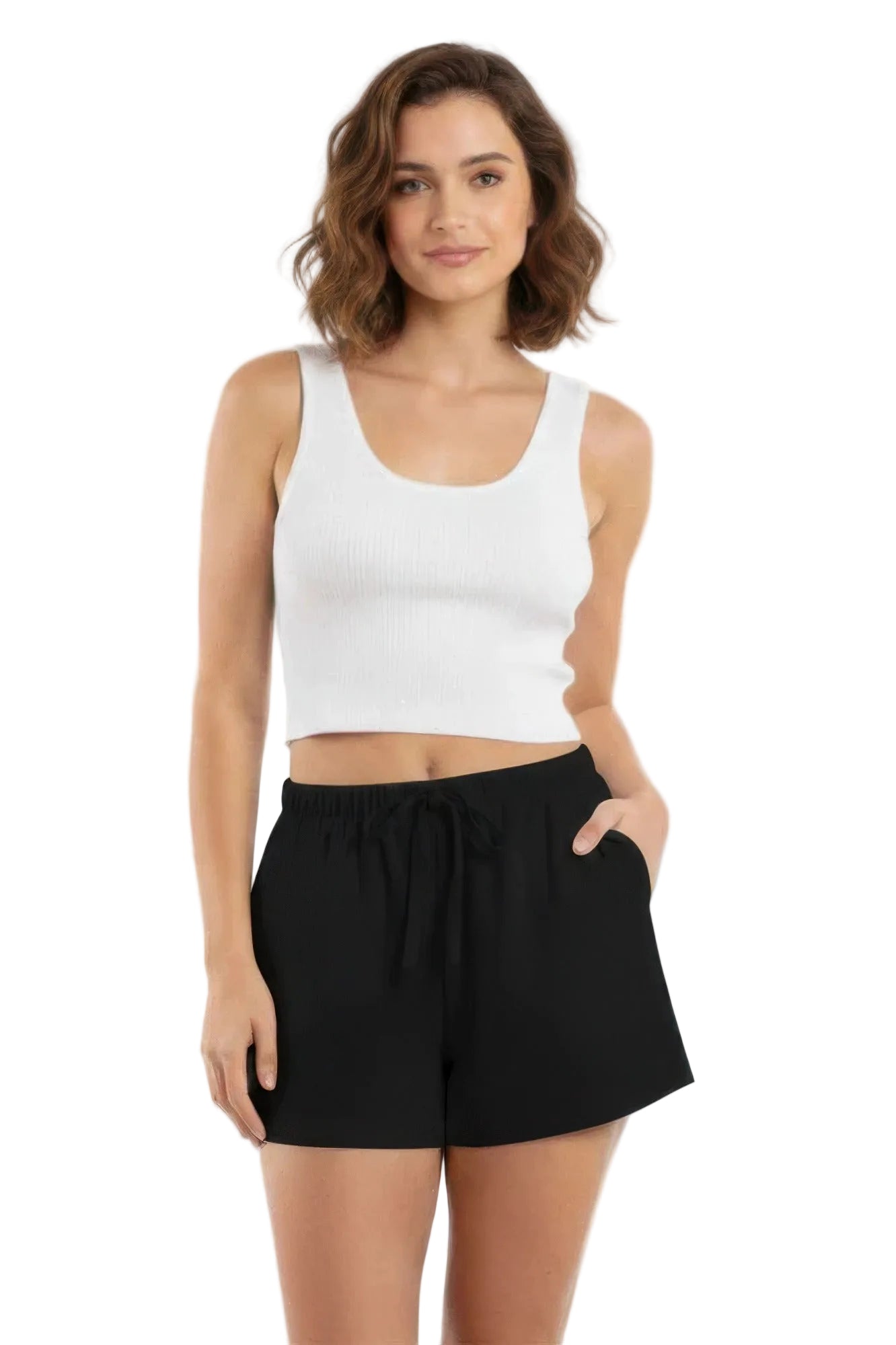 Woman wearing a white tank top and black shorts on a white background
