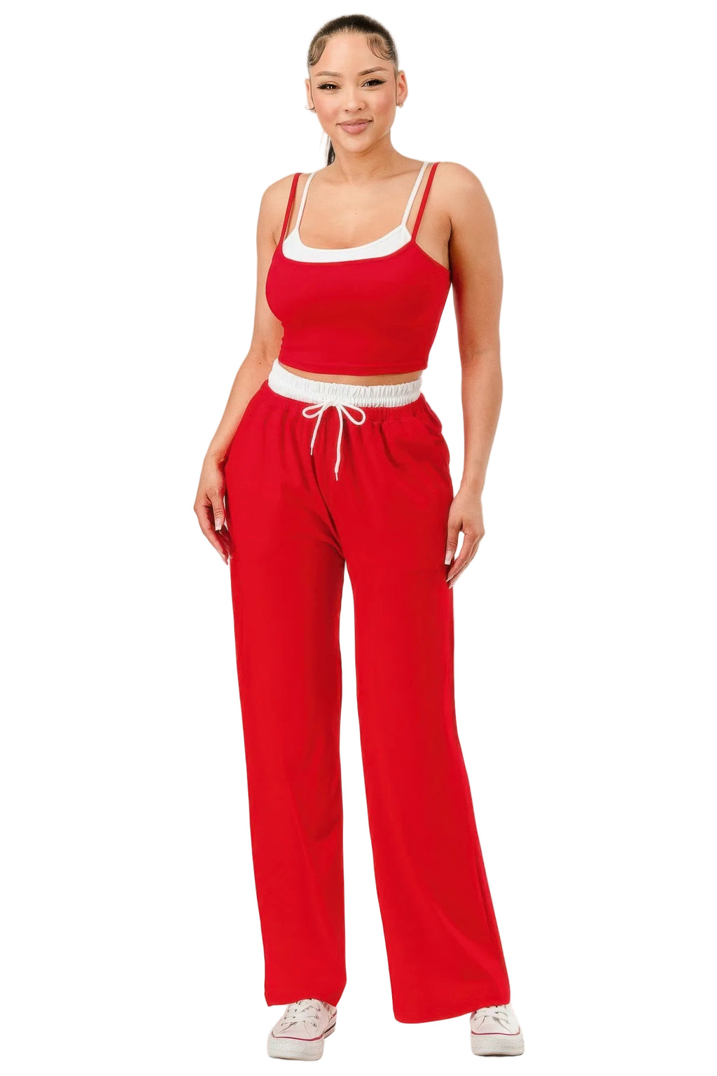 Woman wearing a red outfit with white trim on a white background