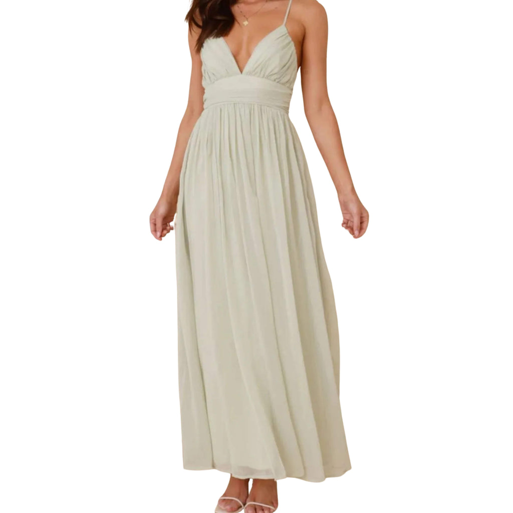Beige cami dress worn by a model on a white background