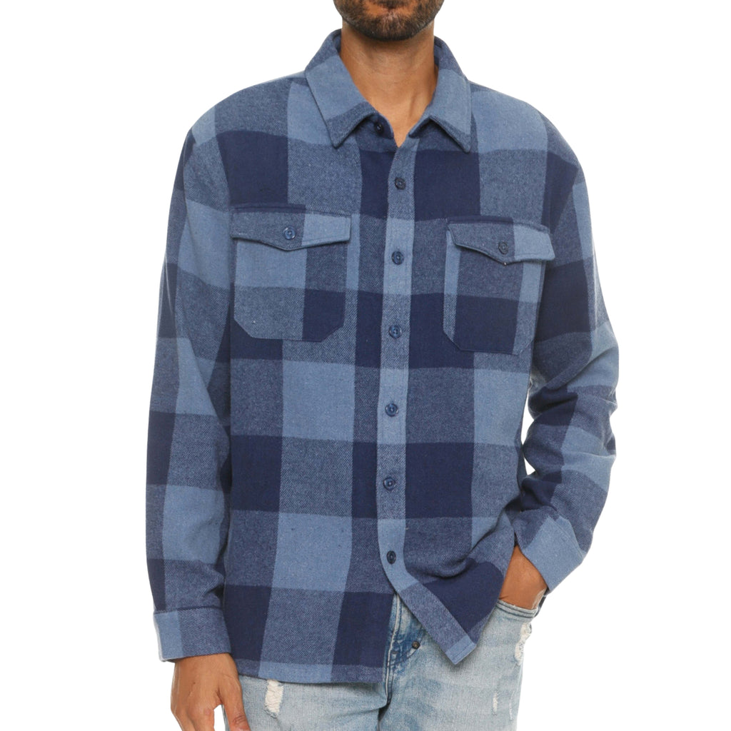 Model wearing a plaid flannel shacket for men, styled casually with jeans. www.urbanitychek.ca