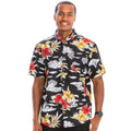 Man wearing a black floral patterned shirt on a white background