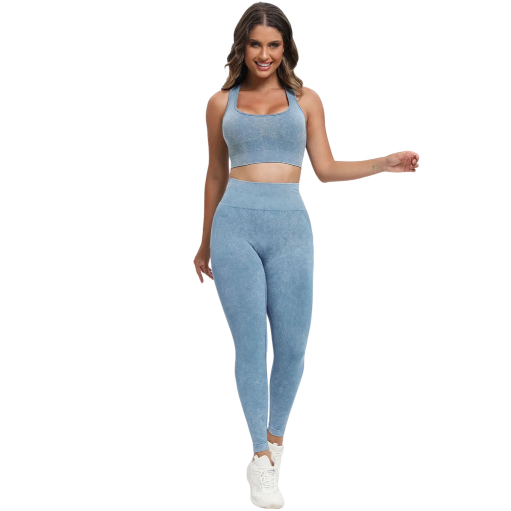A woman wearing a matching blue scoop neck wide strap top and high-waisted leggings active set.