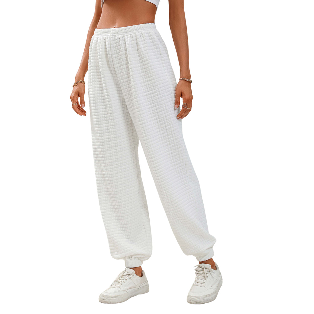 White textured joggers worn by a women on a white background