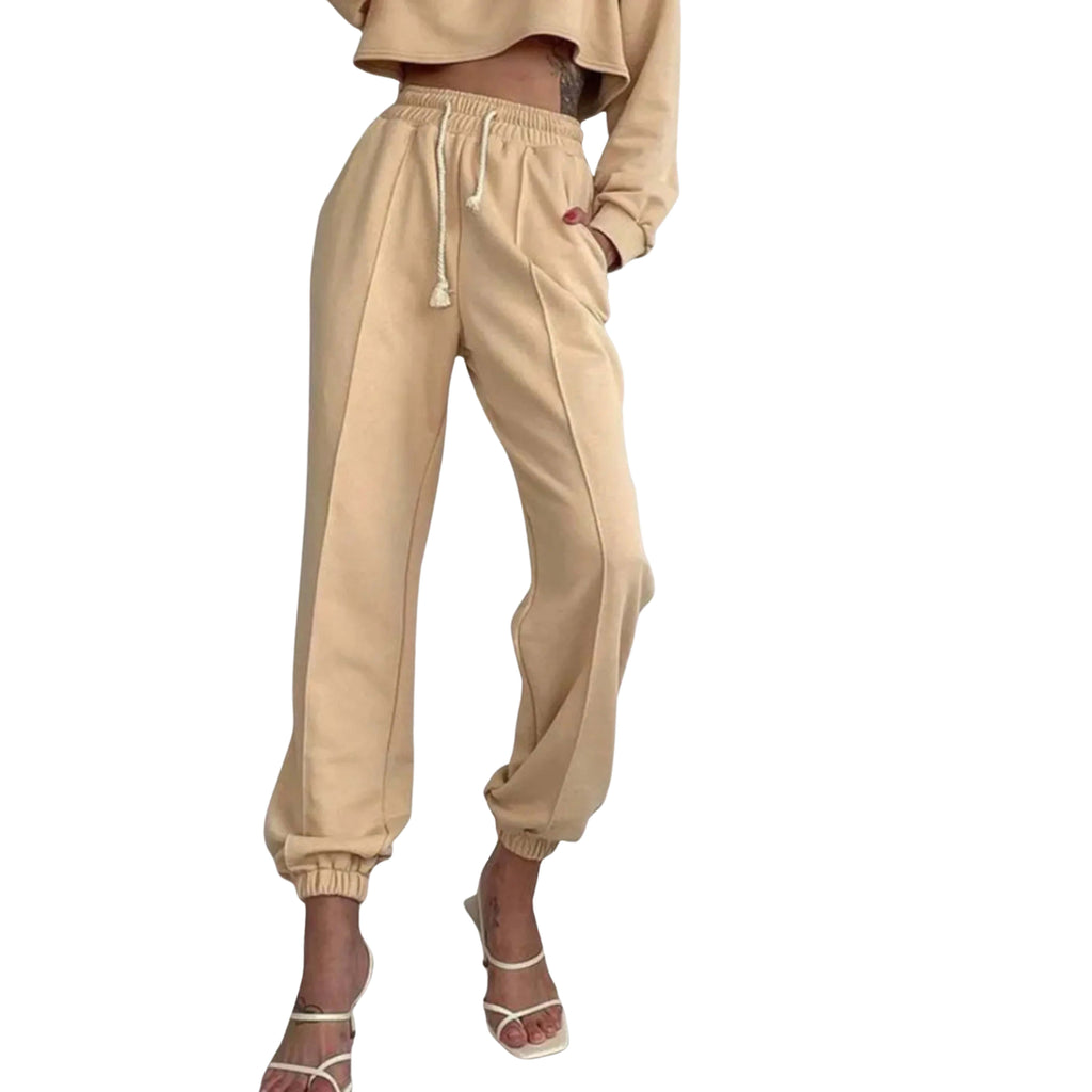 Beige jogger pants worn by a women on a white background