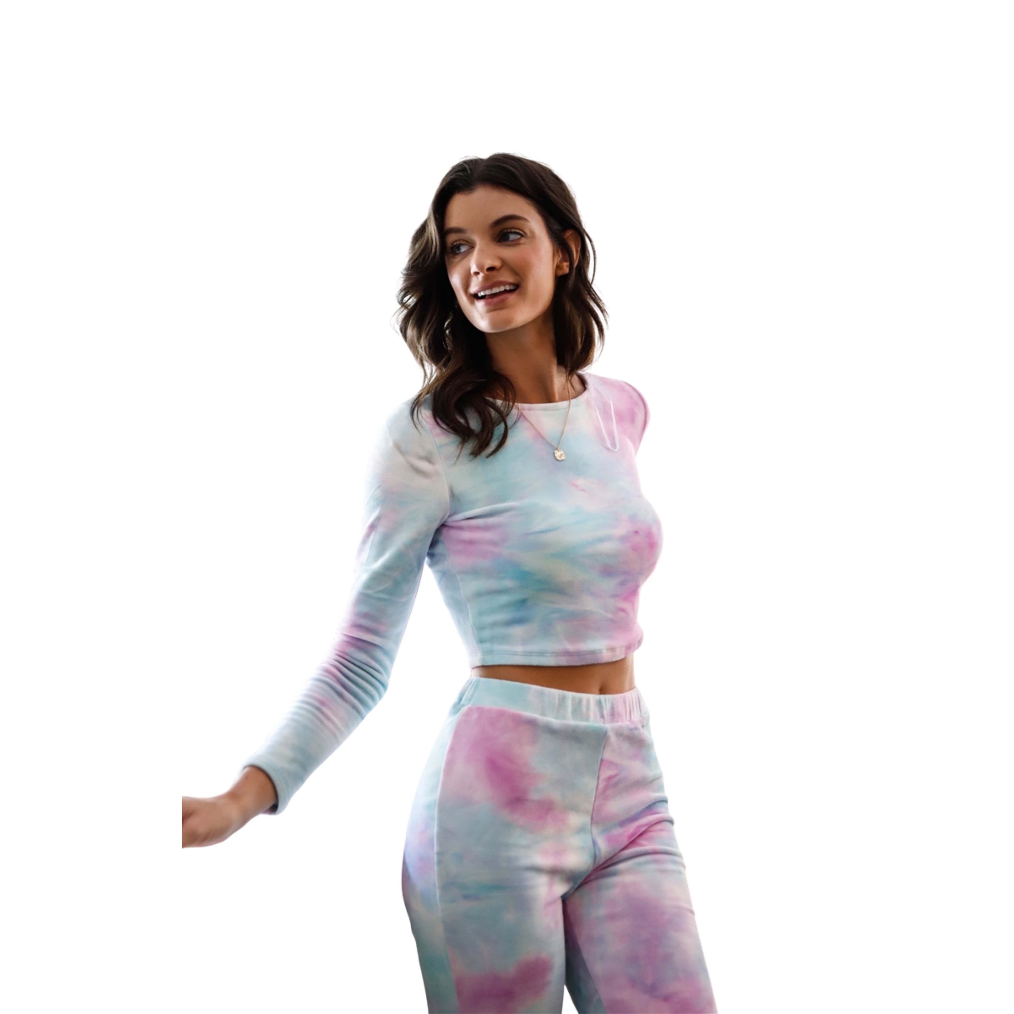 Woman wearing a tie-dye long-sleeve top and pants on a white background
