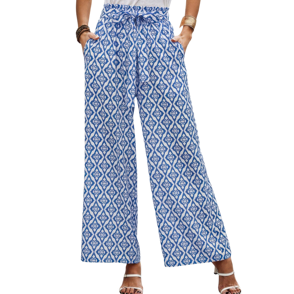 Blue patterned pants worn by a person on a white background
