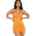 Woman wearing an orange dress on a white background