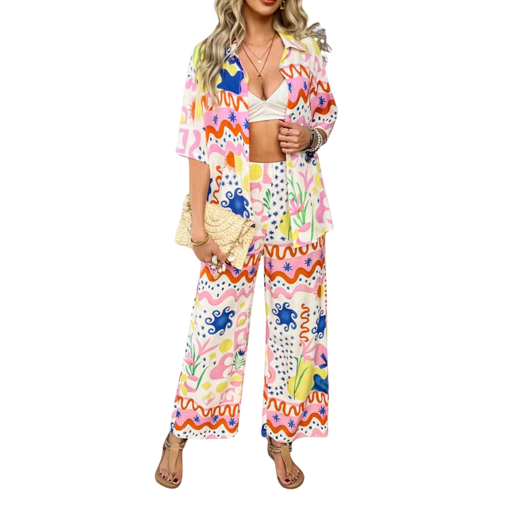 A multicolored, floral button-down shirt and matching pants set worn by a model