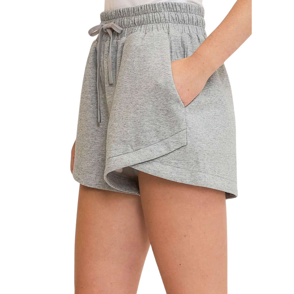 A pair of gray women's sweatshorts with a drawstring waist and pockets.