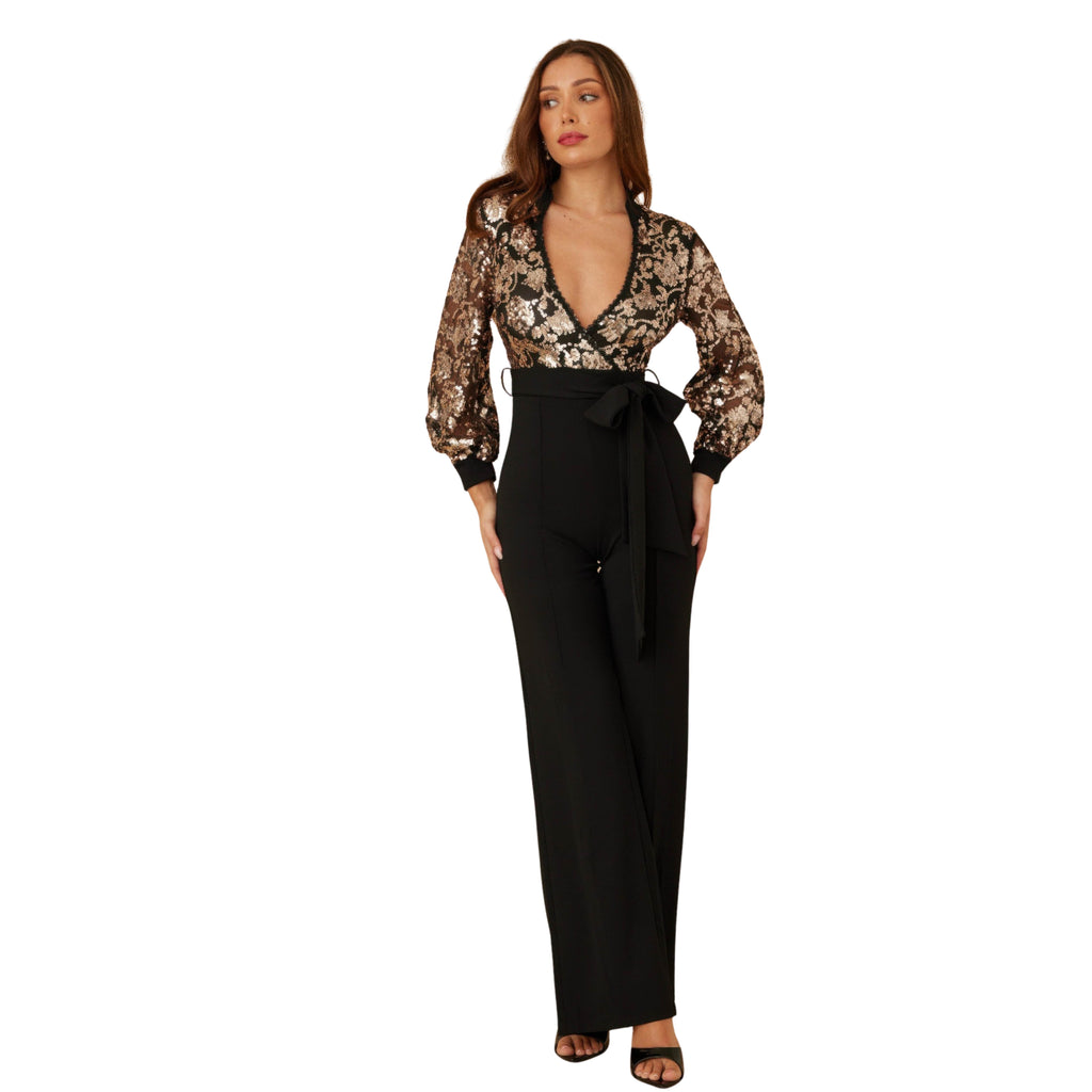 Woman wearing a floral blouse and black pants on a white background