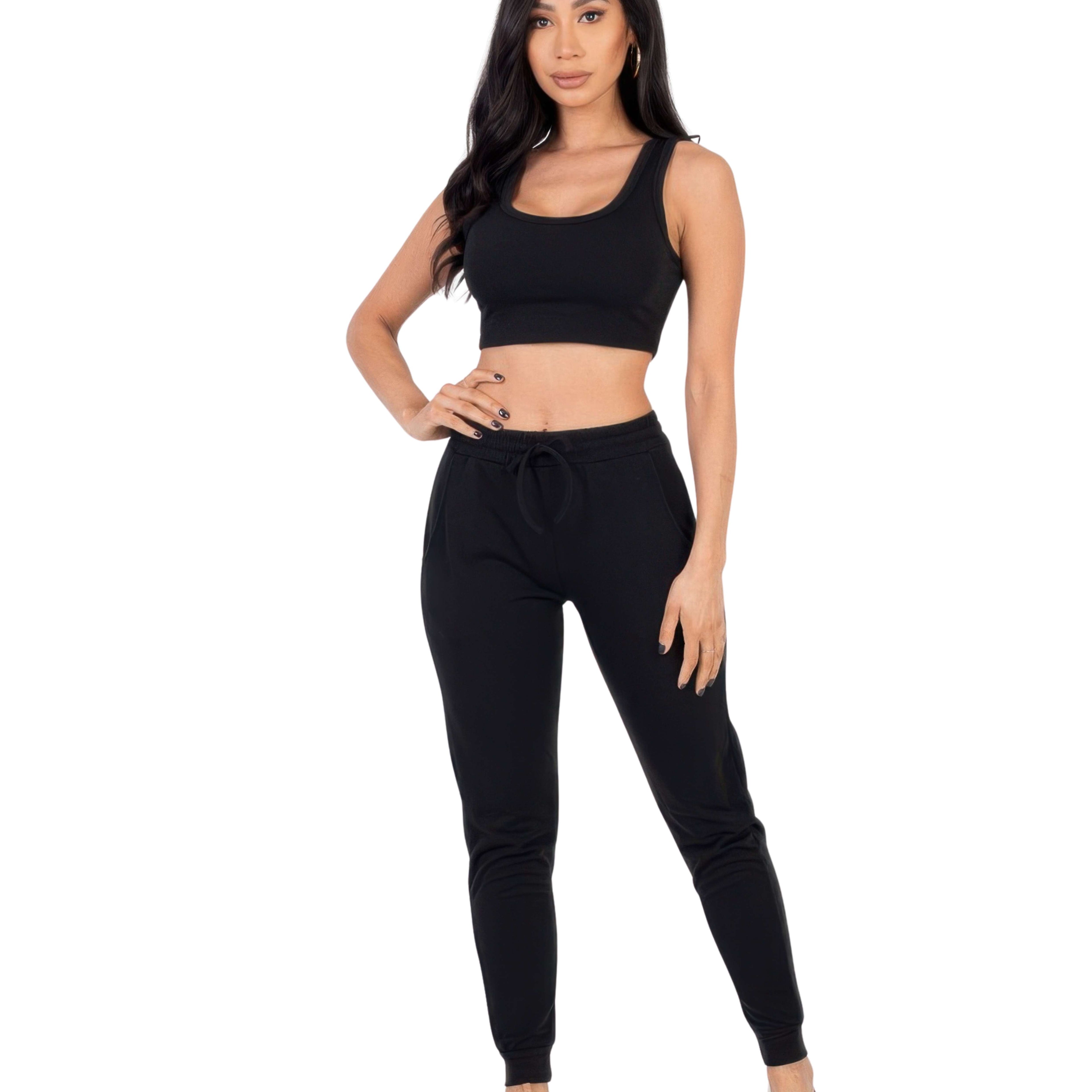 Woman wearing a black jogger set outfit on a white background