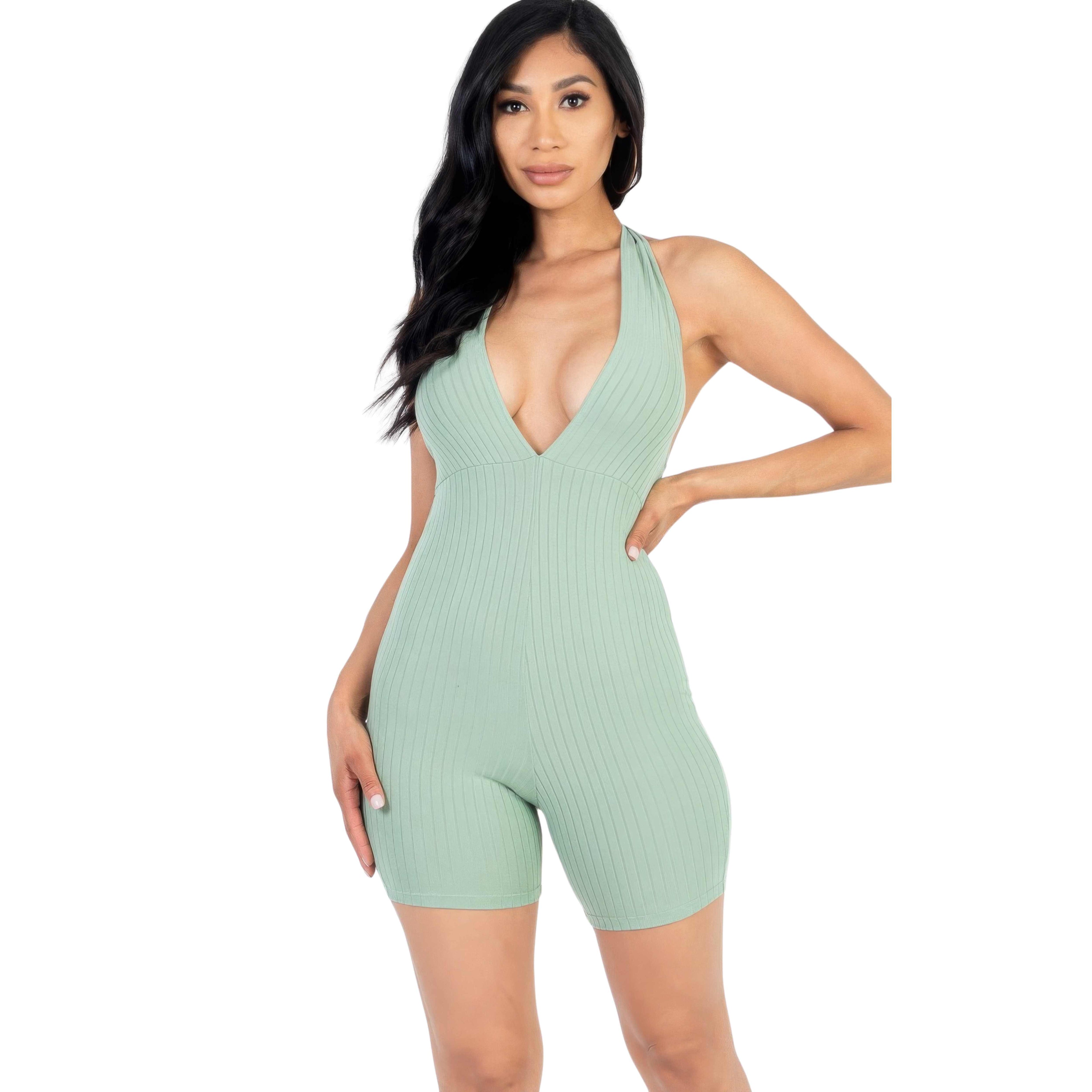 Woman wearing a light green ribbed romper on a white background