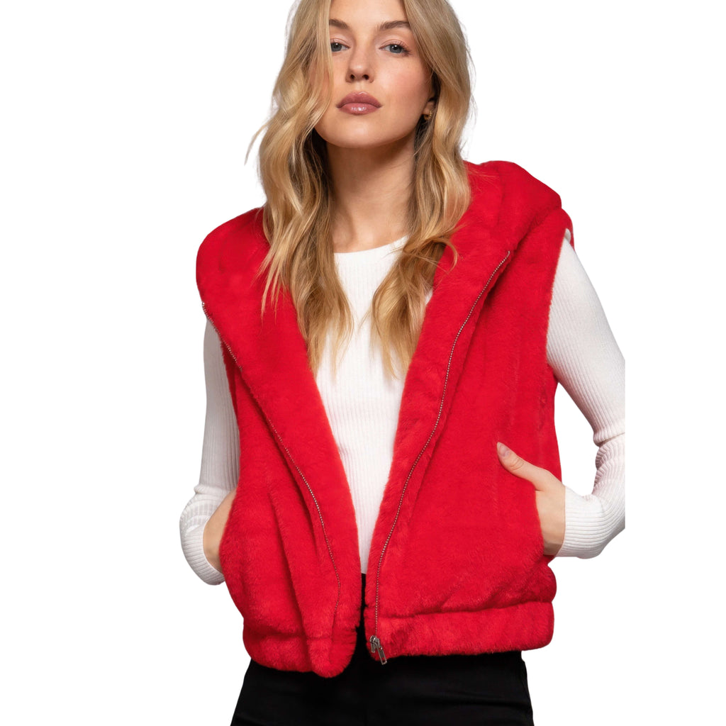Woman wearing a red vest over a white shirt on a white background