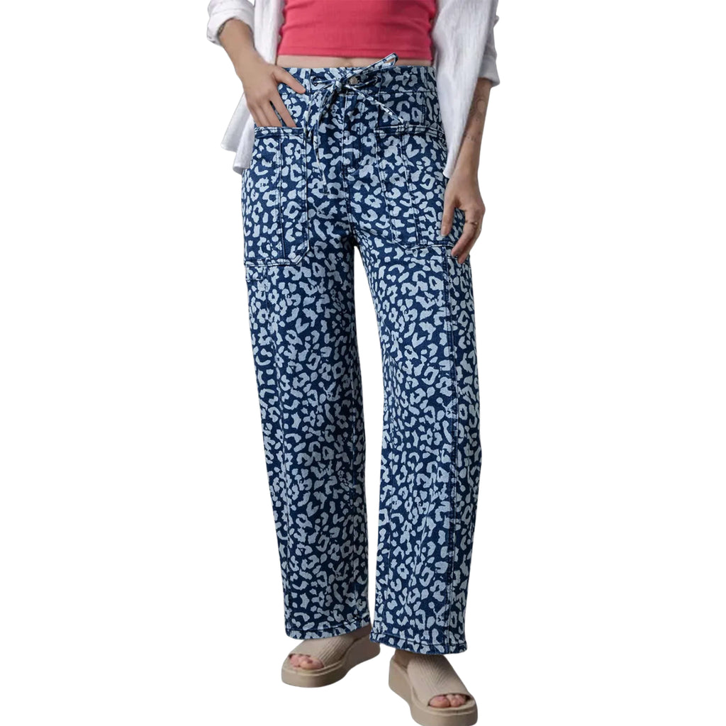 Navy blue patterned wide leg jeans worn by a women on a white background