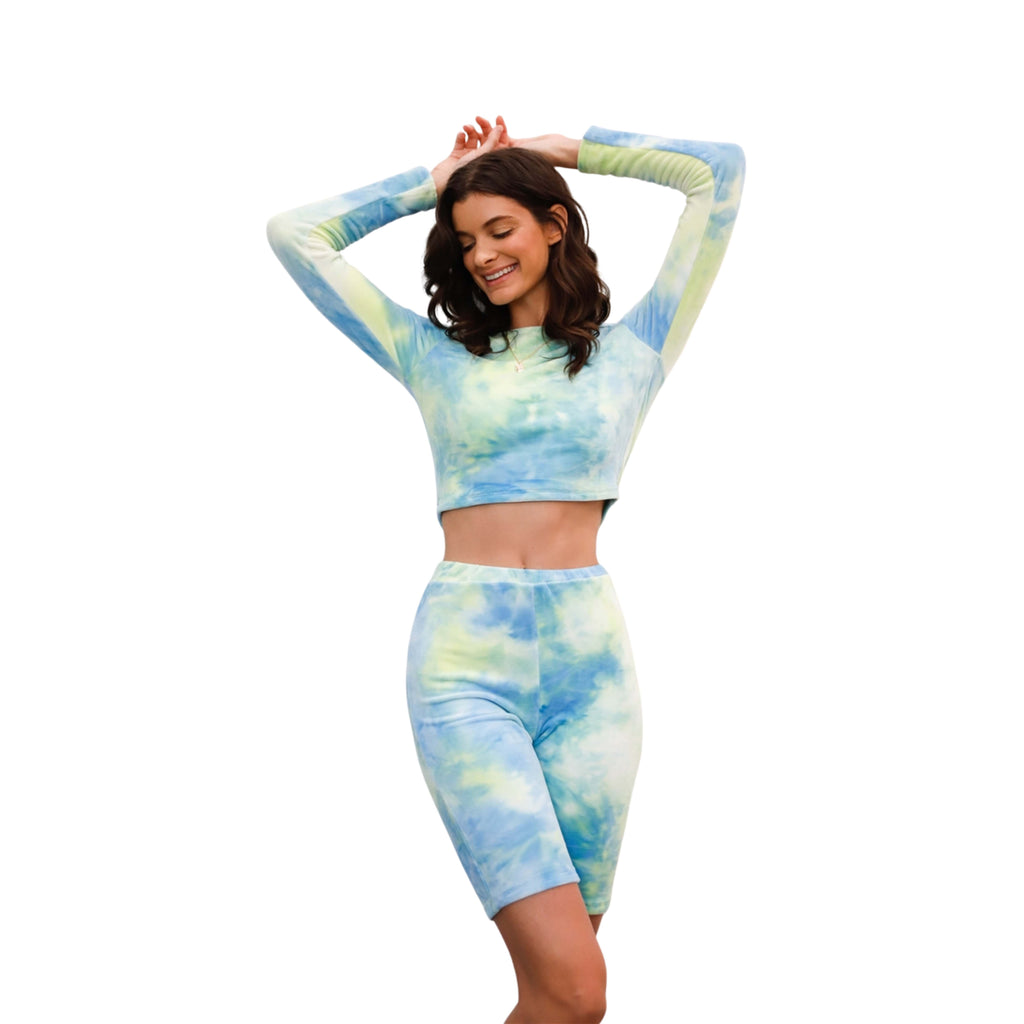 Woman wearing a tie-dye two-piece set on a white background