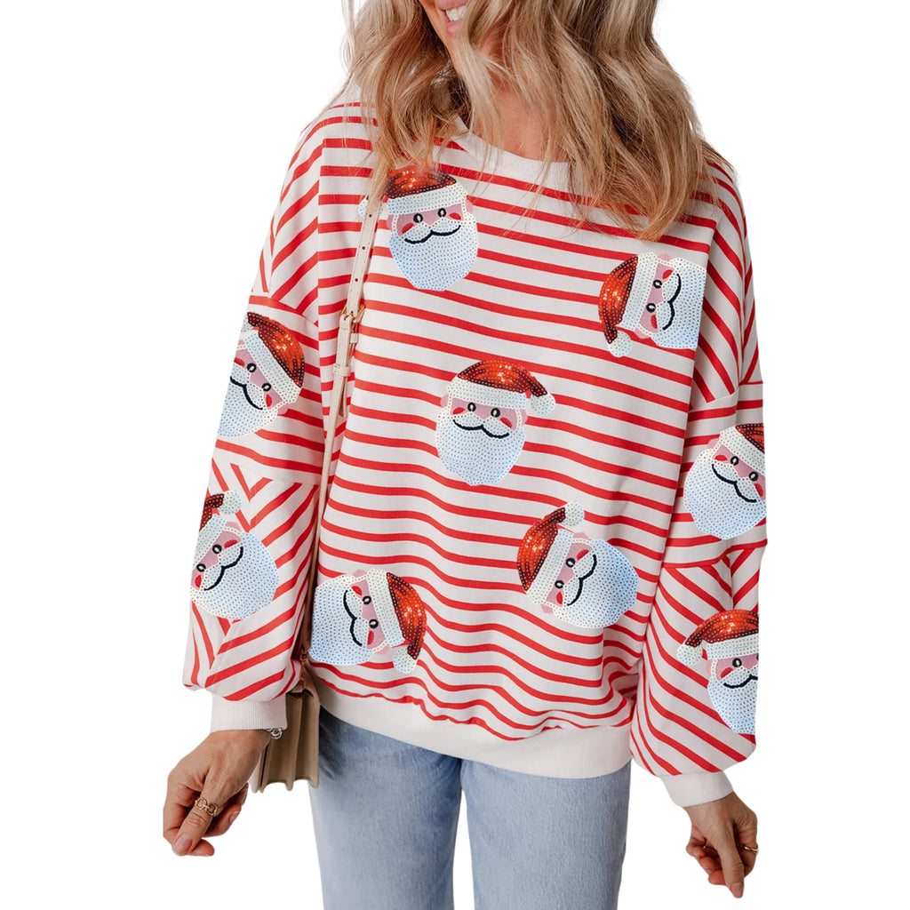 Person wearing a red and white striped sweater with cat designs on a white background