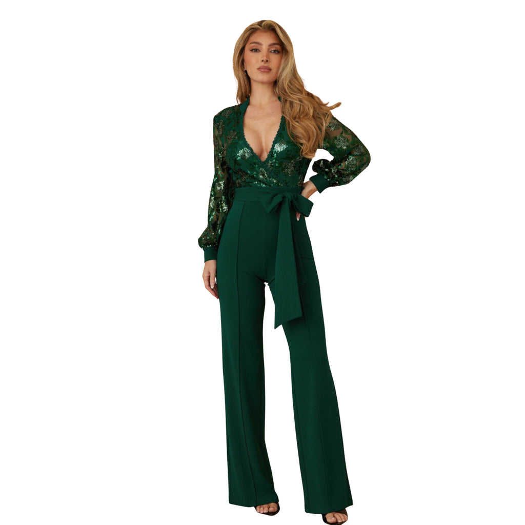 Woman wearing a green jumpsuit with a white background