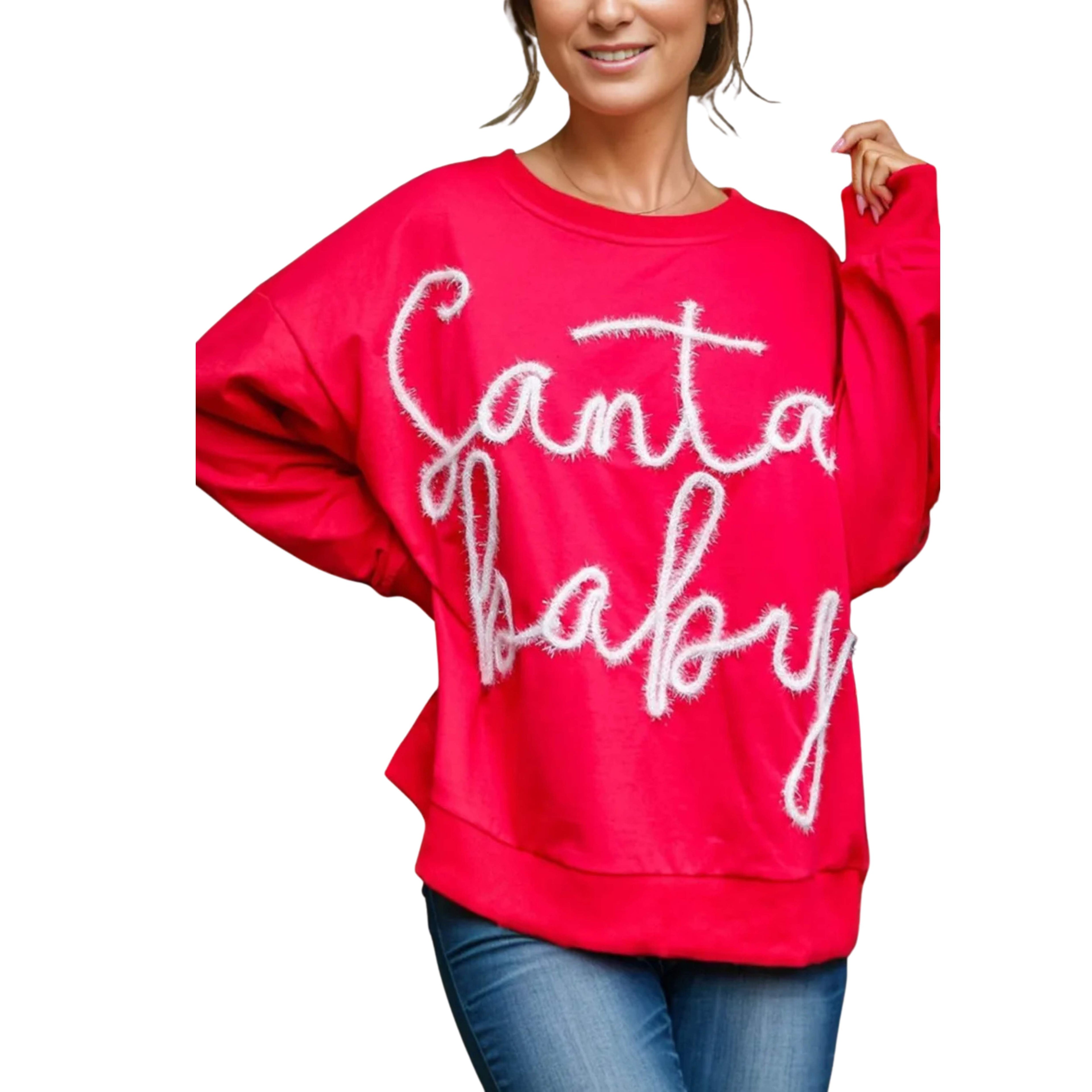 Red sweatshirt with 'Santa Baby' text worn by a person on a white background