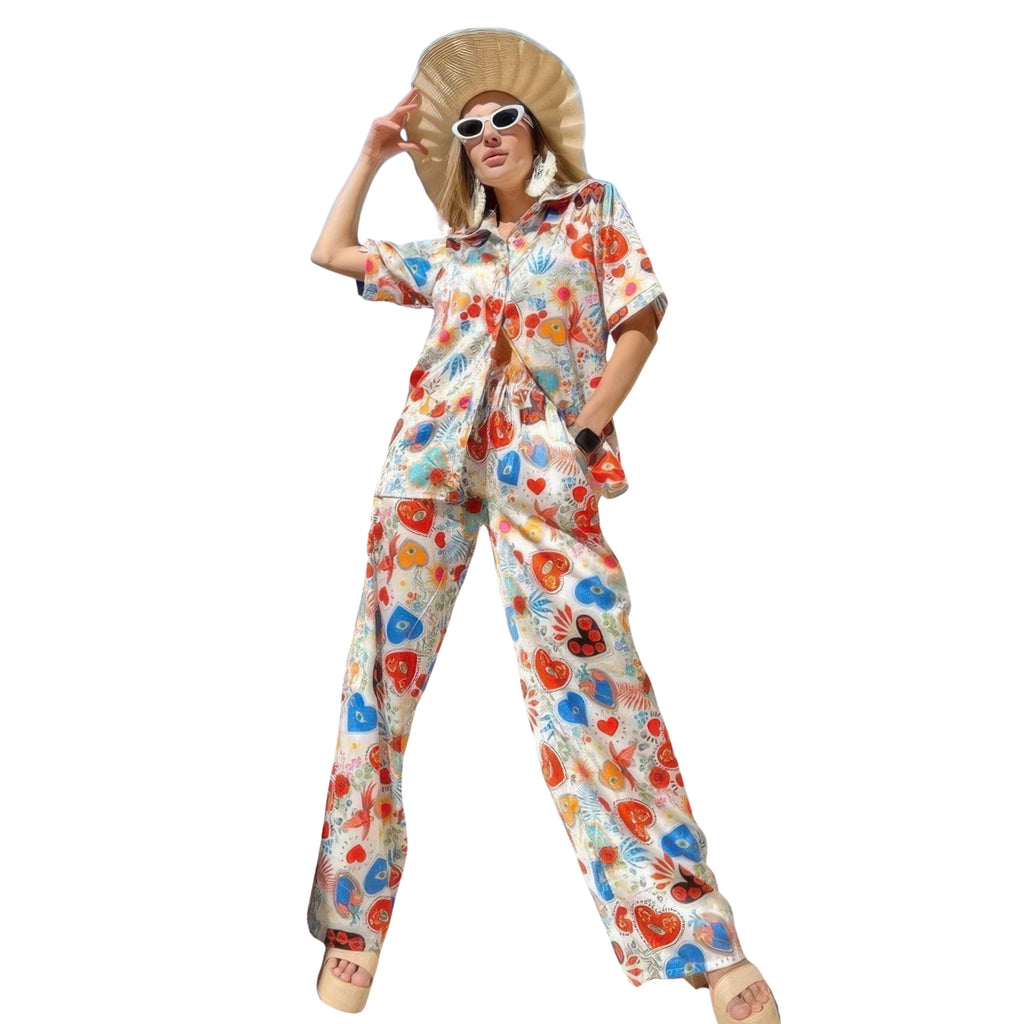Person wearing a colorful floral jumpsuit on a white background