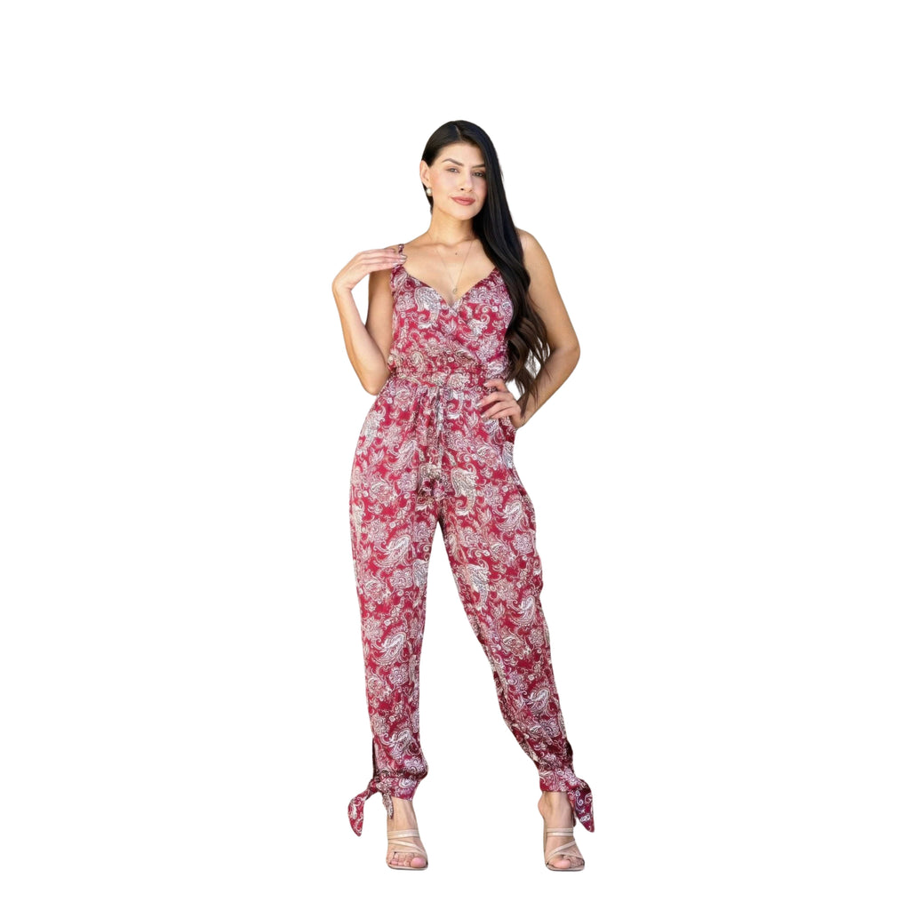 Woman wearing a red floral jumpsuit on a white background
