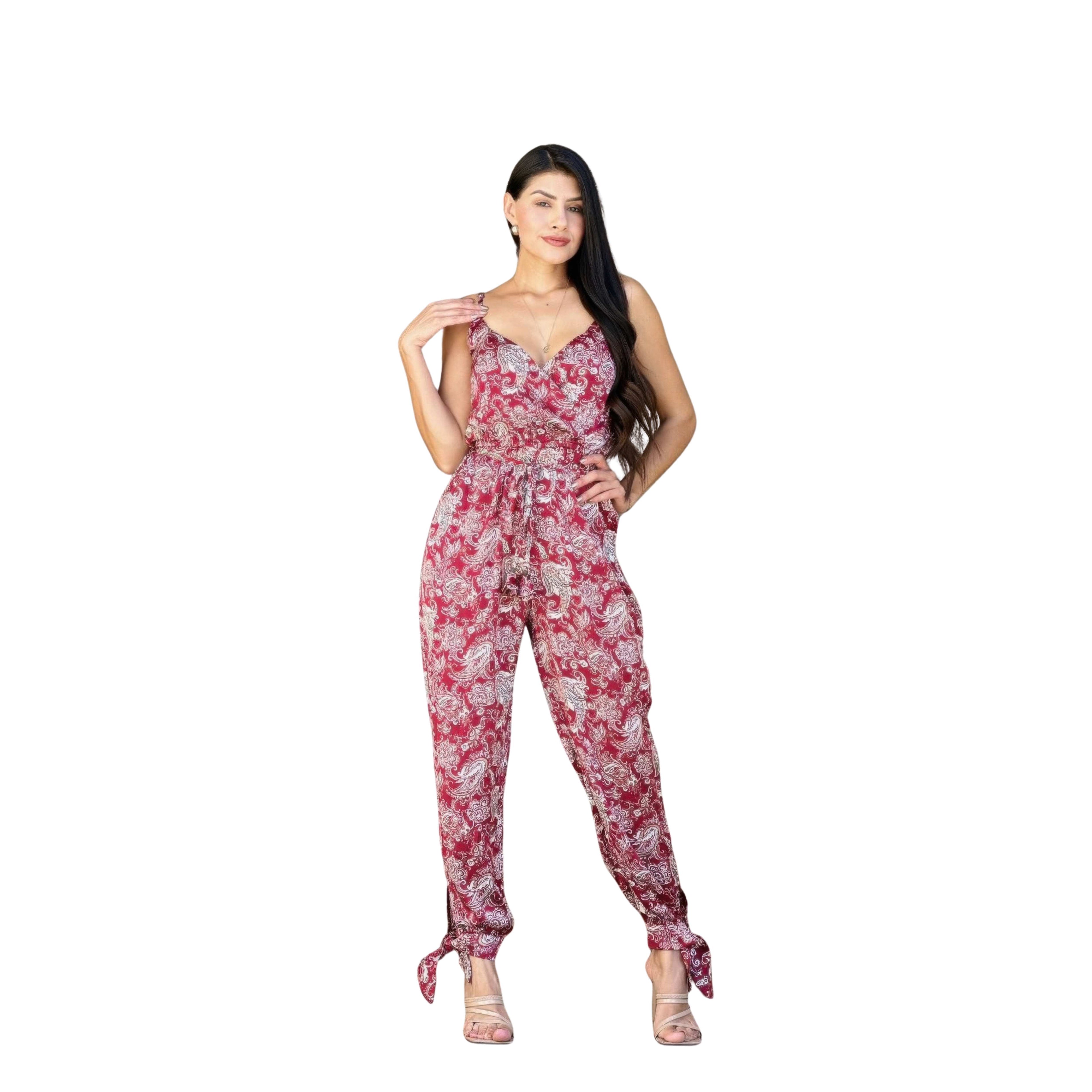 Woman wearing a red floral jumpsuit on a white background