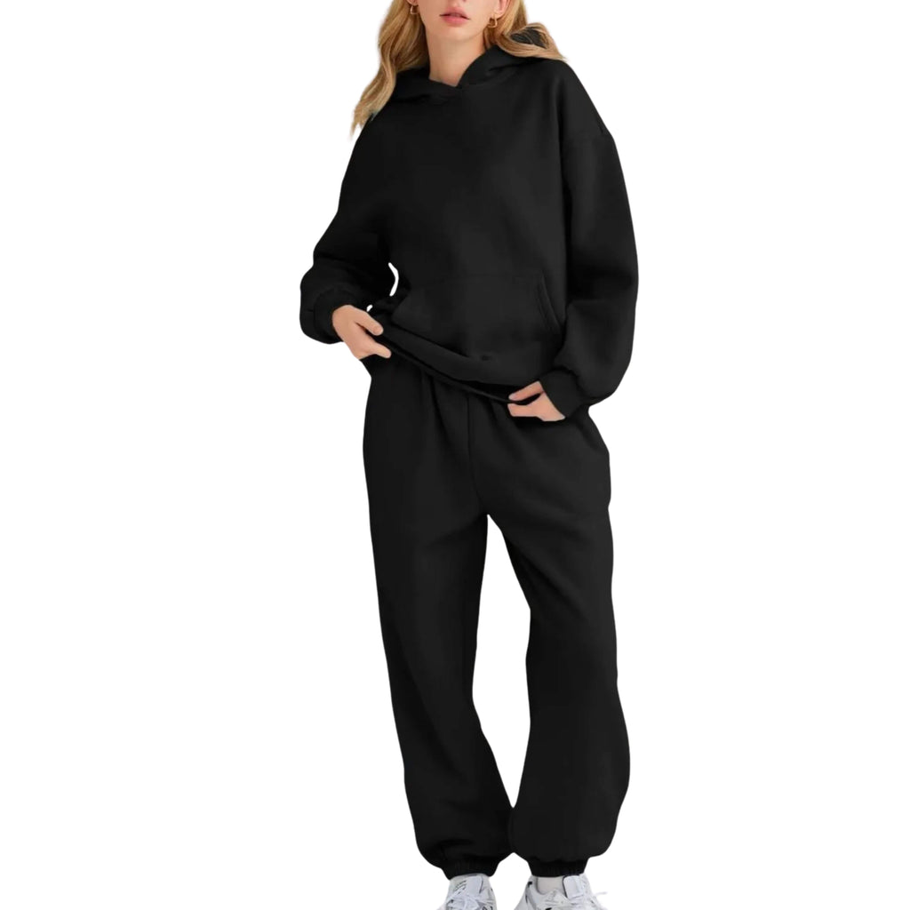 Person wearing a black tracksuit on a white background