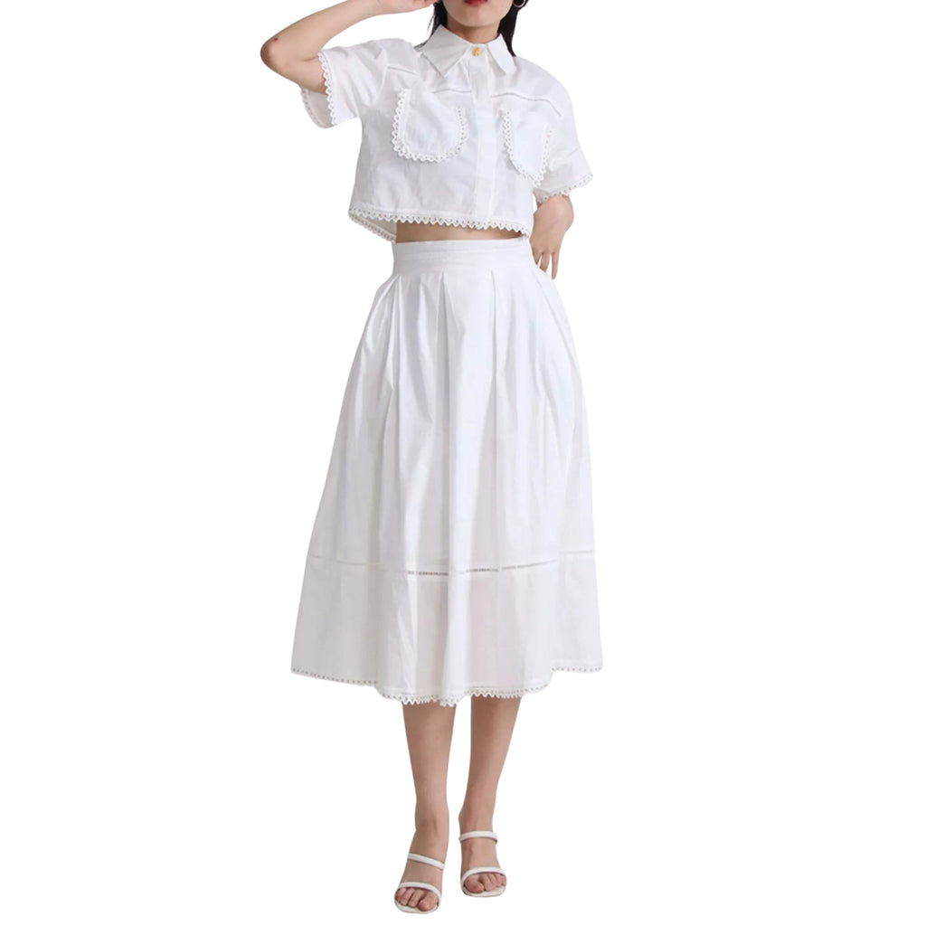 White outfit with a top and skirt on a white background