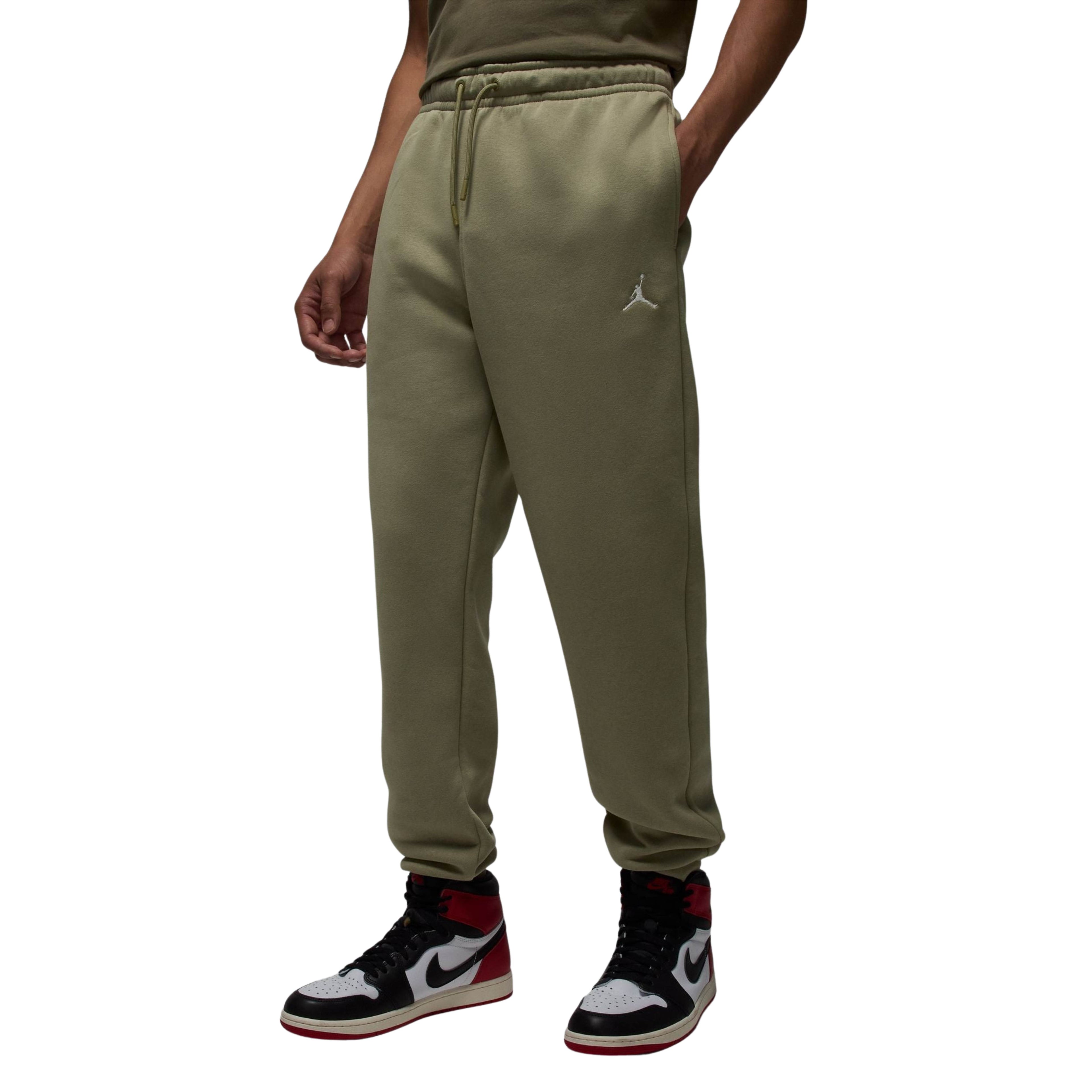 Person wearing olive green sweatpants with a brand logo on a white background
