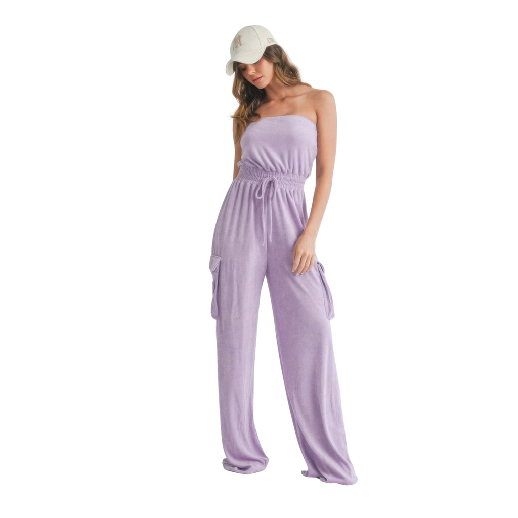 Woman wearing a strapless lavender jumpsuit on a white background