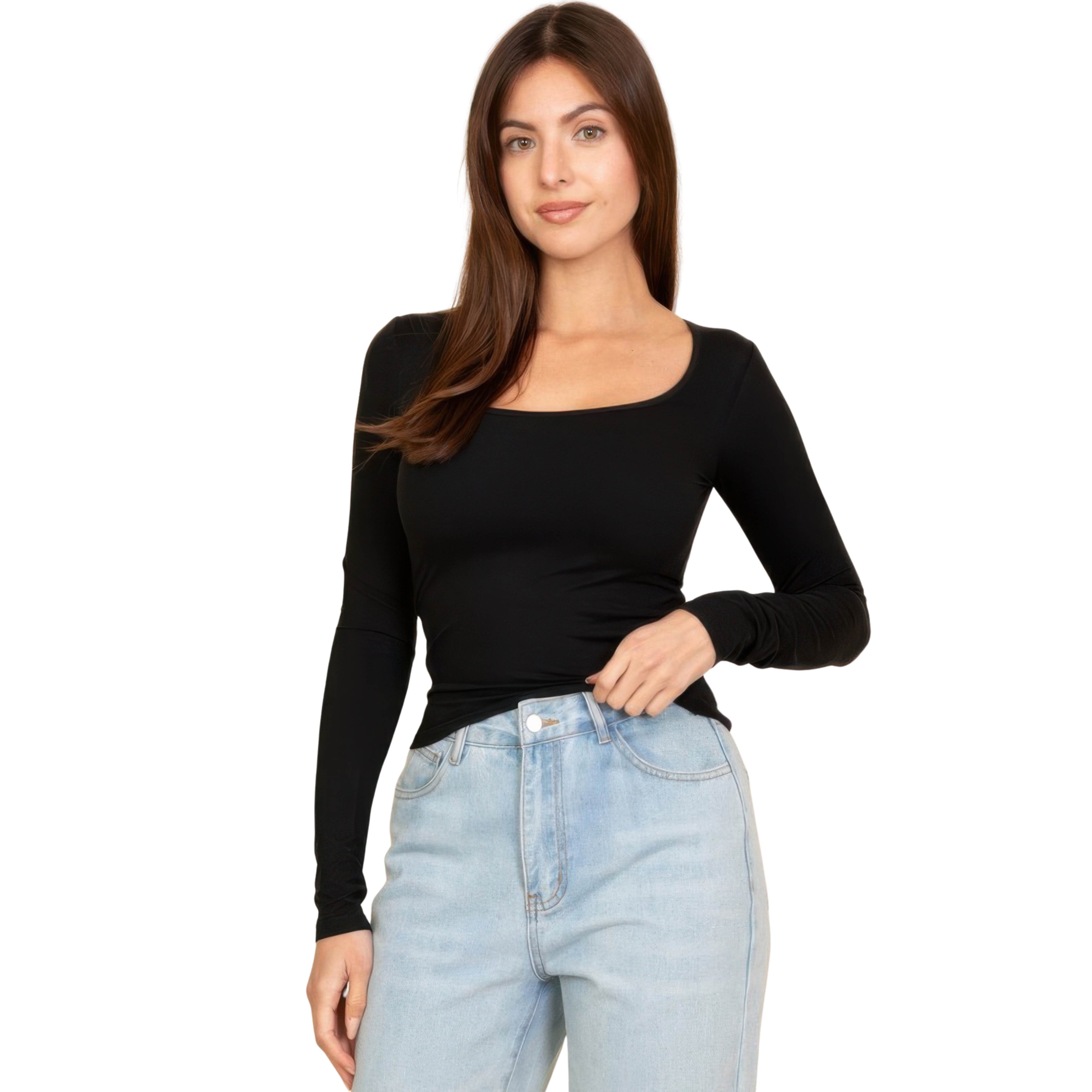 Woman wearing a black long-sleeve top and light blue jeans on a white background
