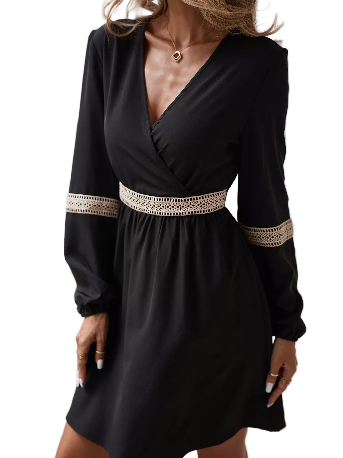 Black dress with long sleeves and lace details worn by a person indoors.