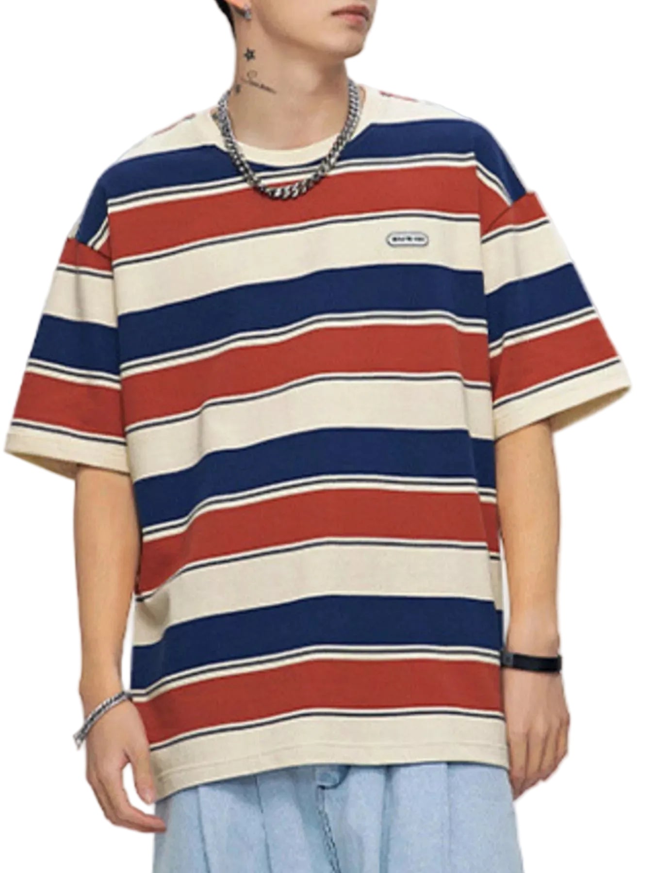 Person wearing a striped t-shirt with red, blue, and beige horizontal stripes on a plain background.