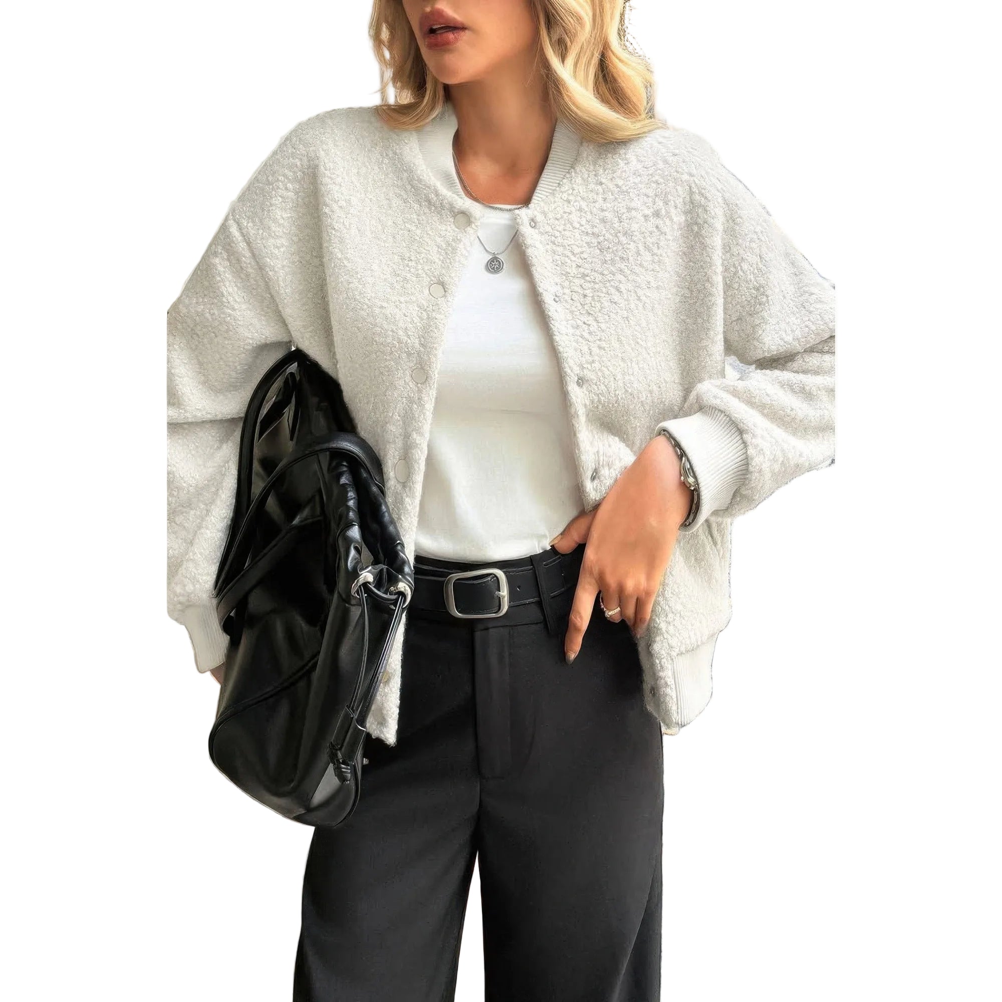 Woman wearing a white textured cardigan, white shirt, black pants, and holding a black bag.